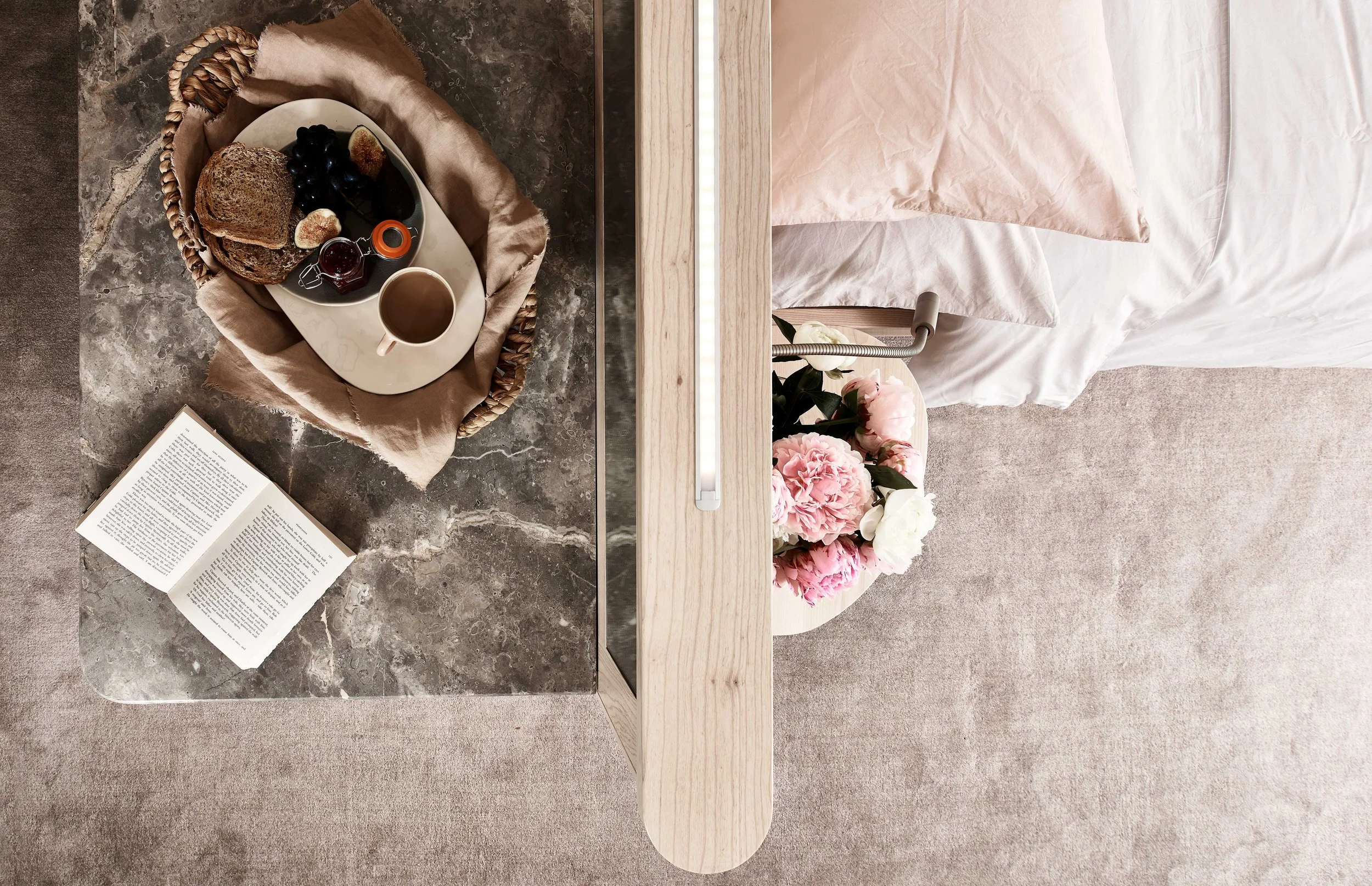 Island bed with Maron marble surface and inset beaded lighting, Surrey master bedroom