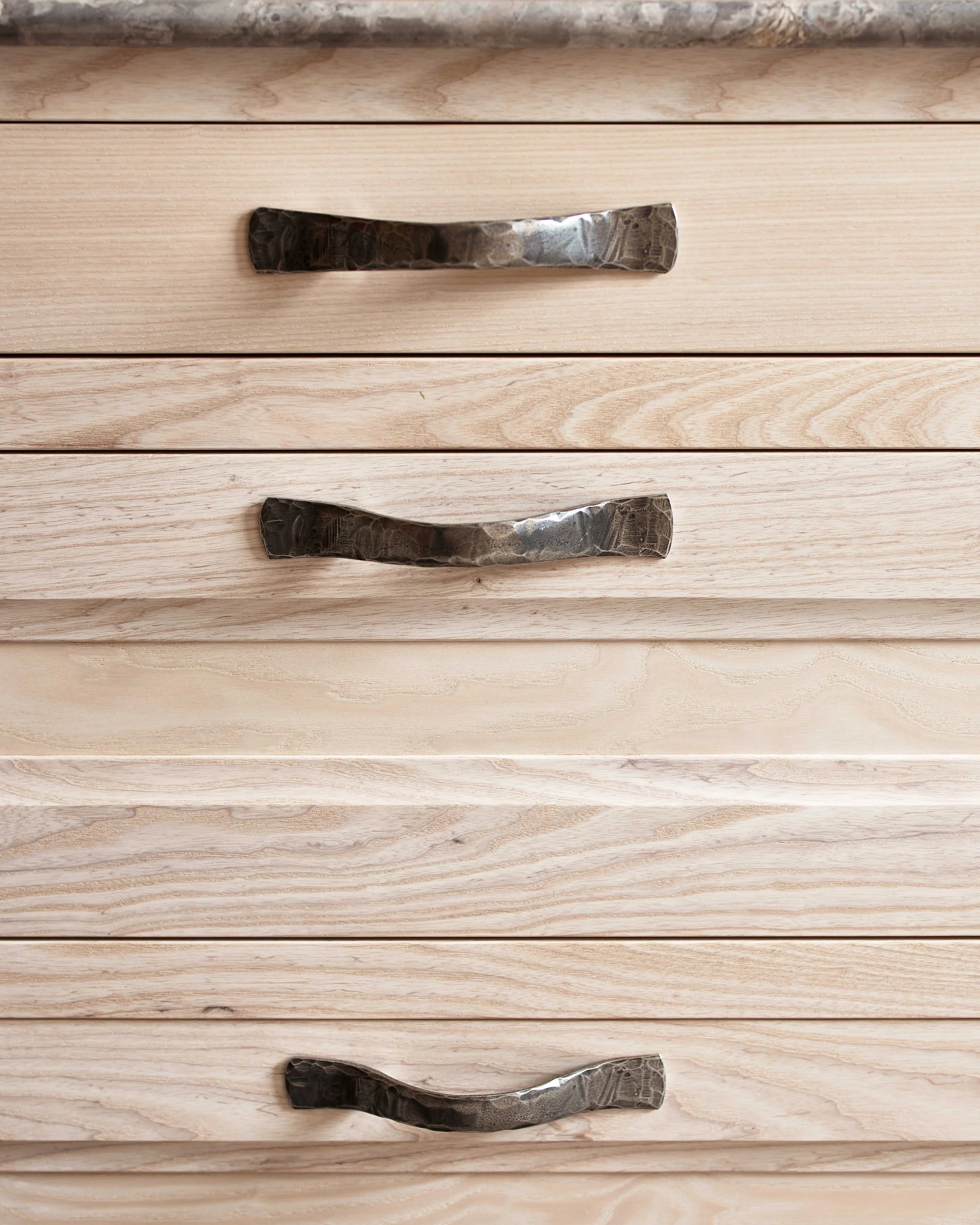 Close-up of handcrafted oak drawers showing fine joinery and natural wood grain.