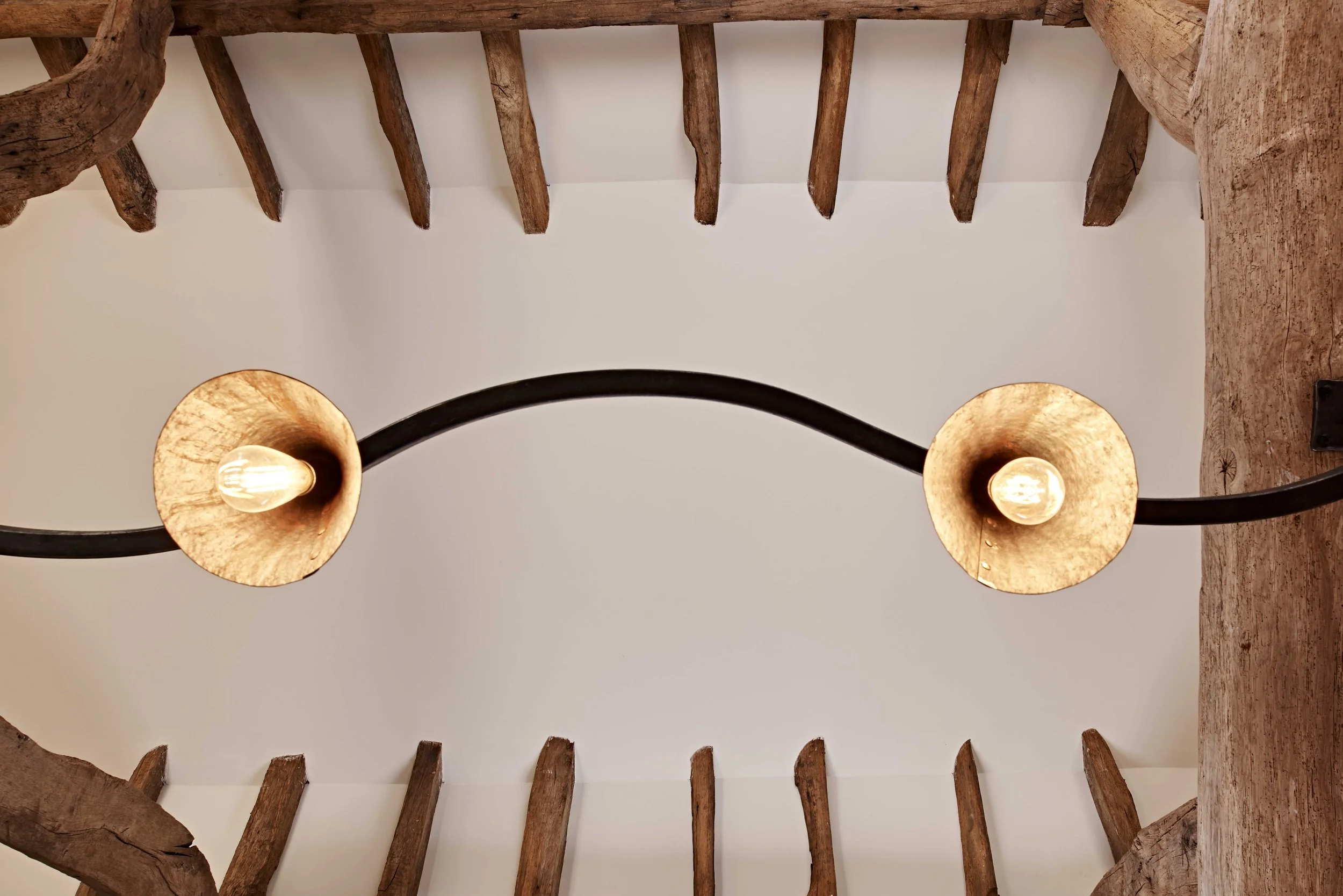 Bespoke forged iron handmade lighting designed for Surrey interiors project.