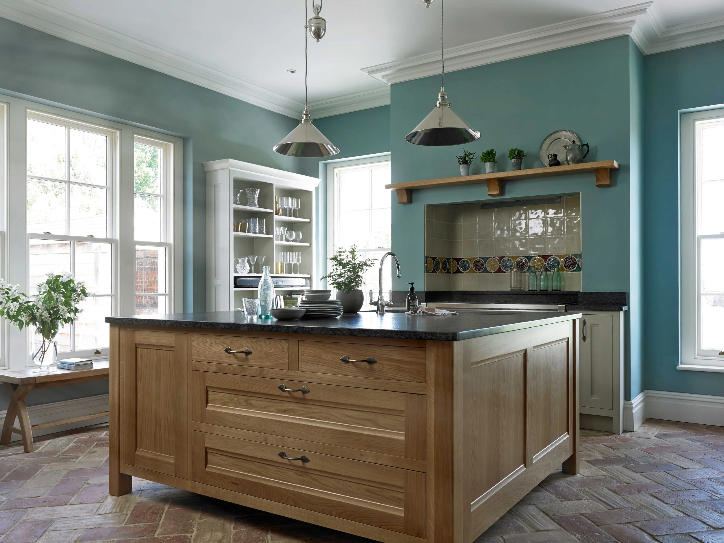 Large handmade oak kitchen island in blue Georgian-style Surrey kitchen with Aga.