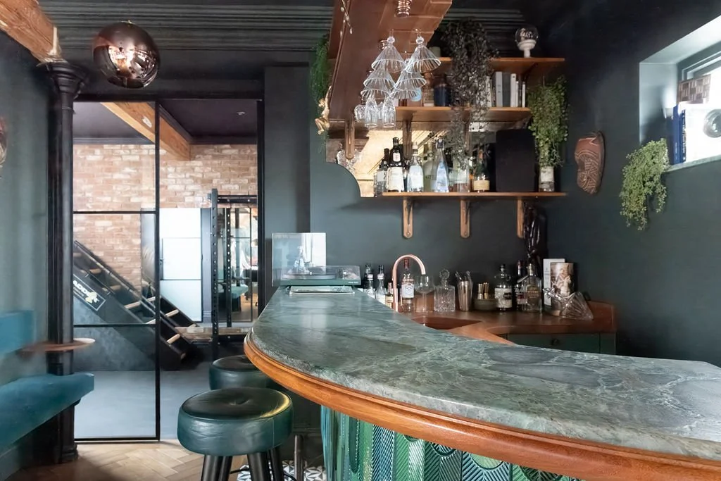 Original stable posts retained within contemporary bar design, Surrey