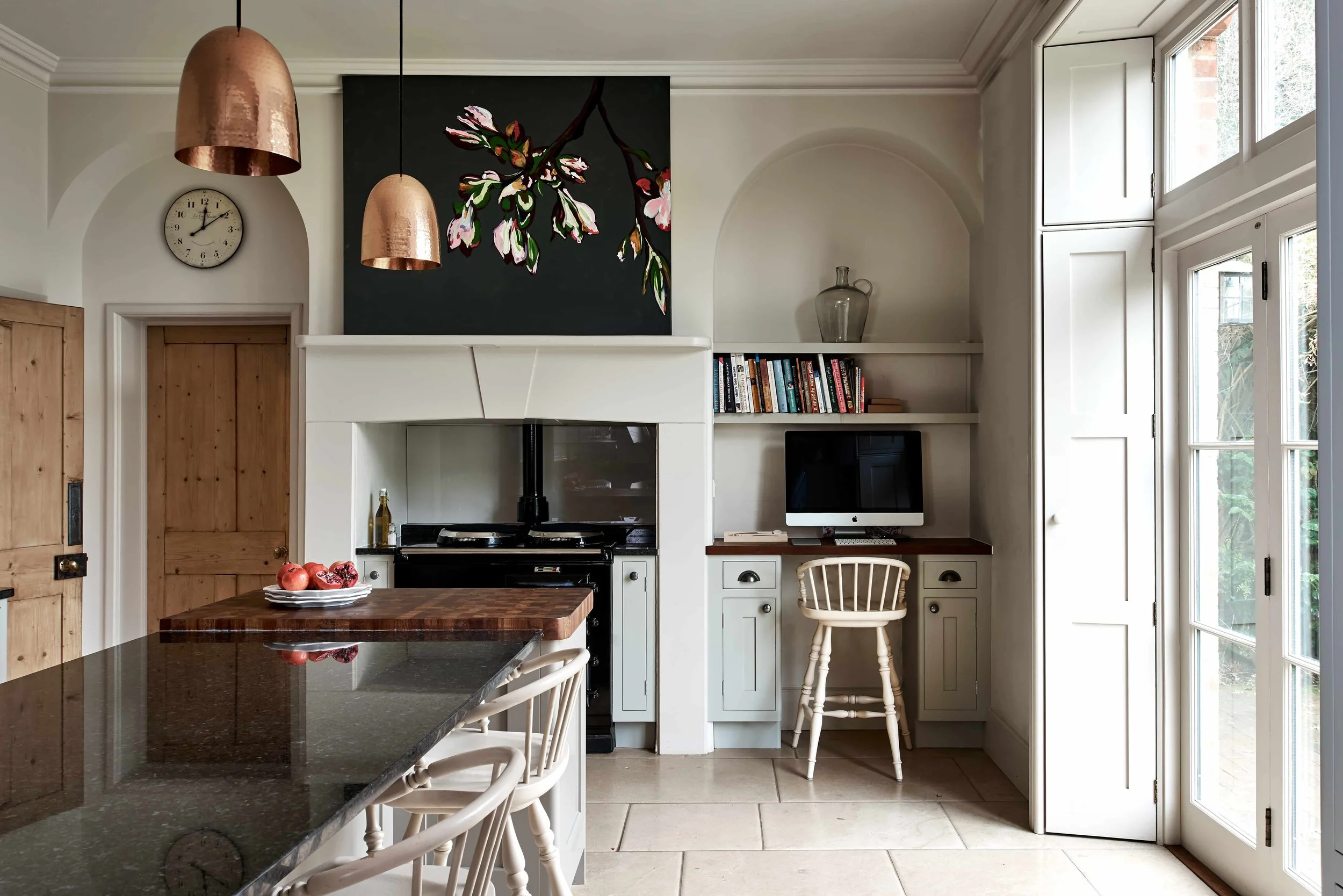 Aga cooker and built-in desk nook within bespoke handmade kitchen design in Guildford.