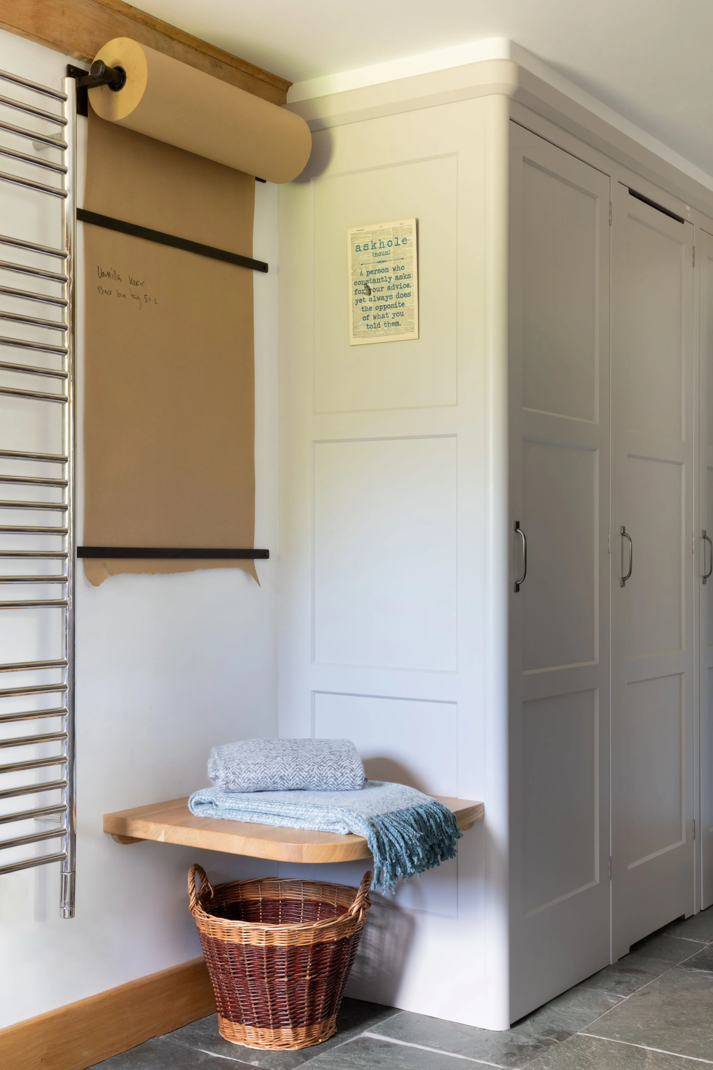 Handmade boot room in Surrey with bespoke seat, cabinetry and paper reminder roll.