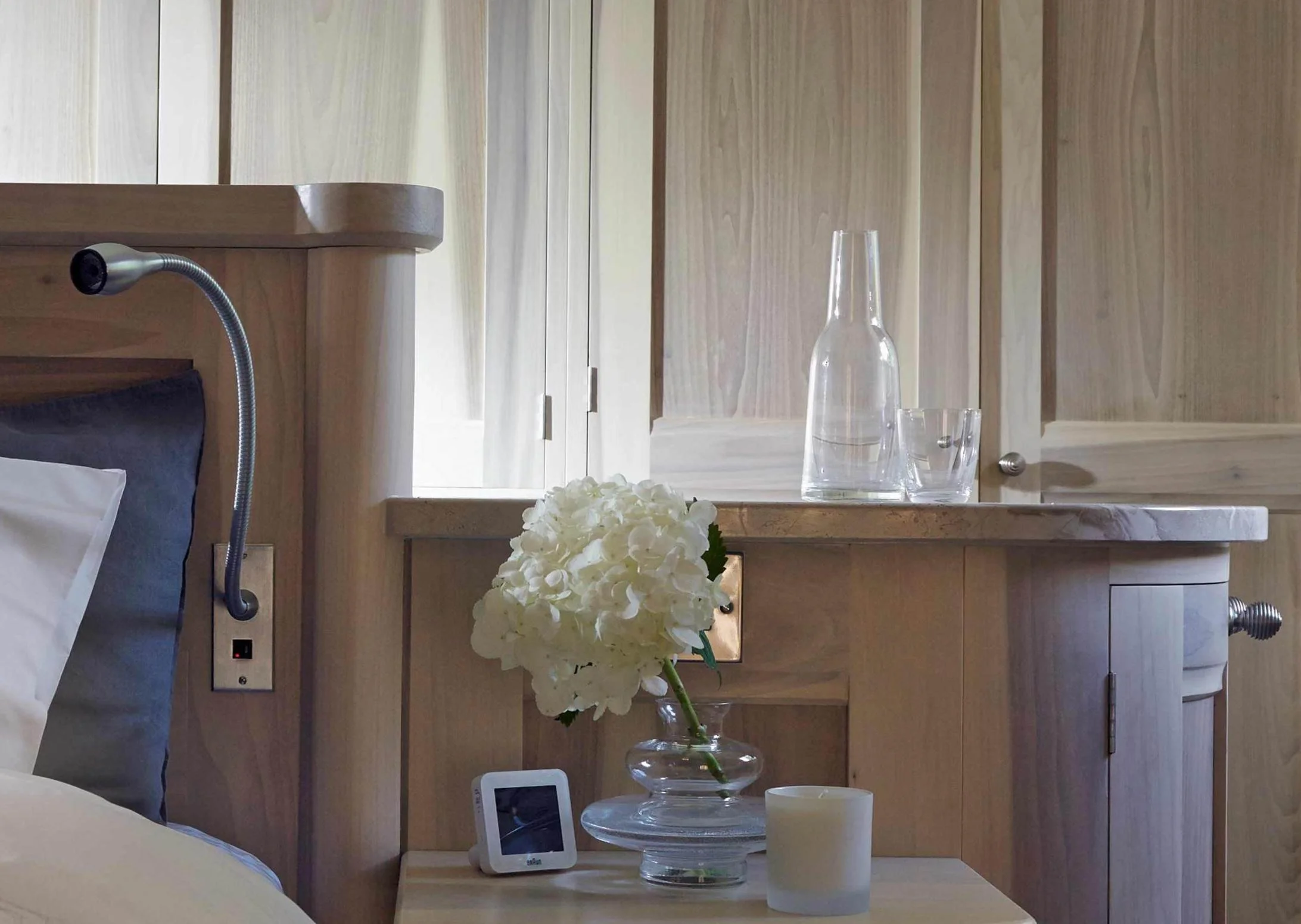Integrated dressing area within bedhead cabinetry, bespoke Surrey bedroom