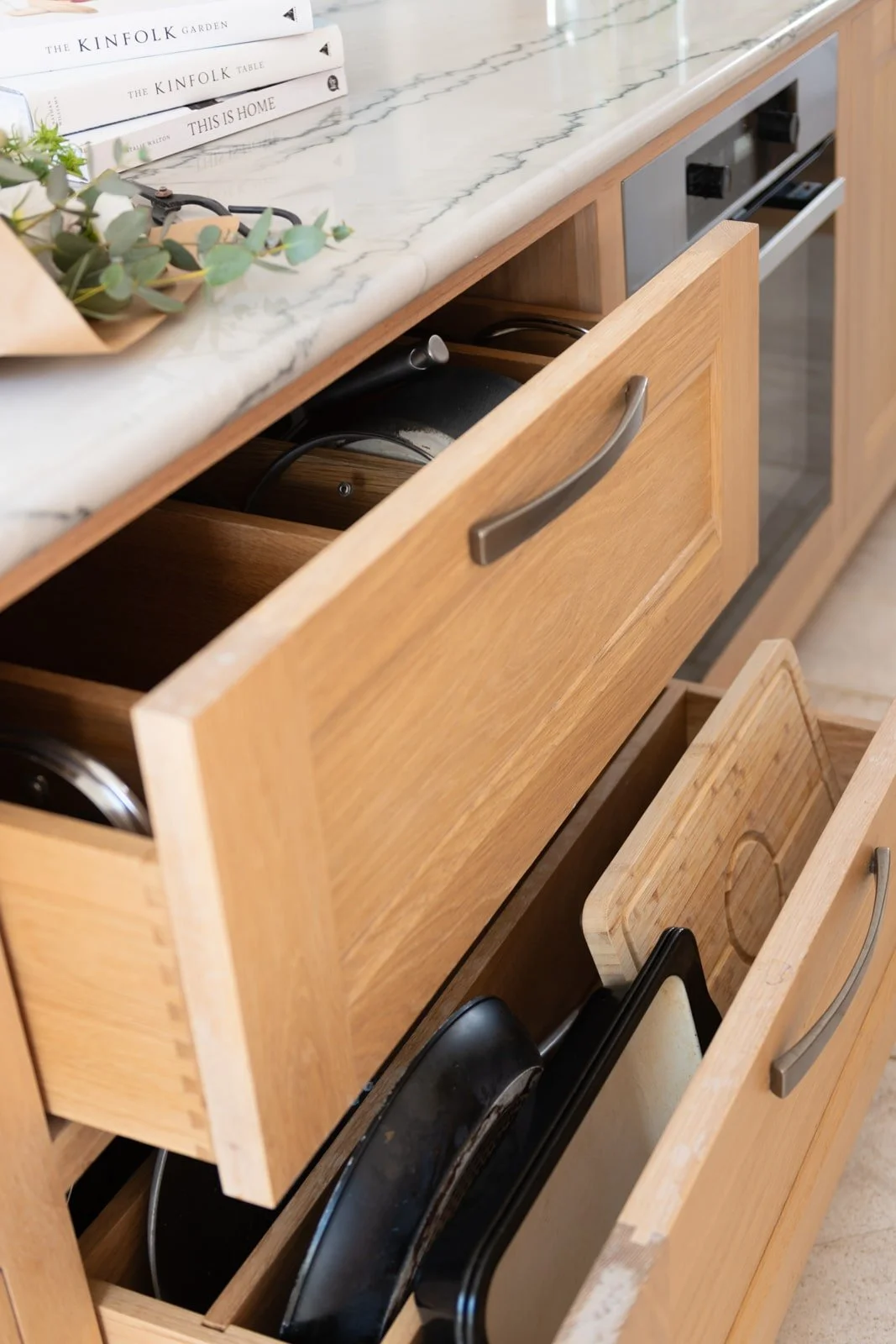 Handmade deep pan drawers in bespoke contemporary kitchen island in Guildford.