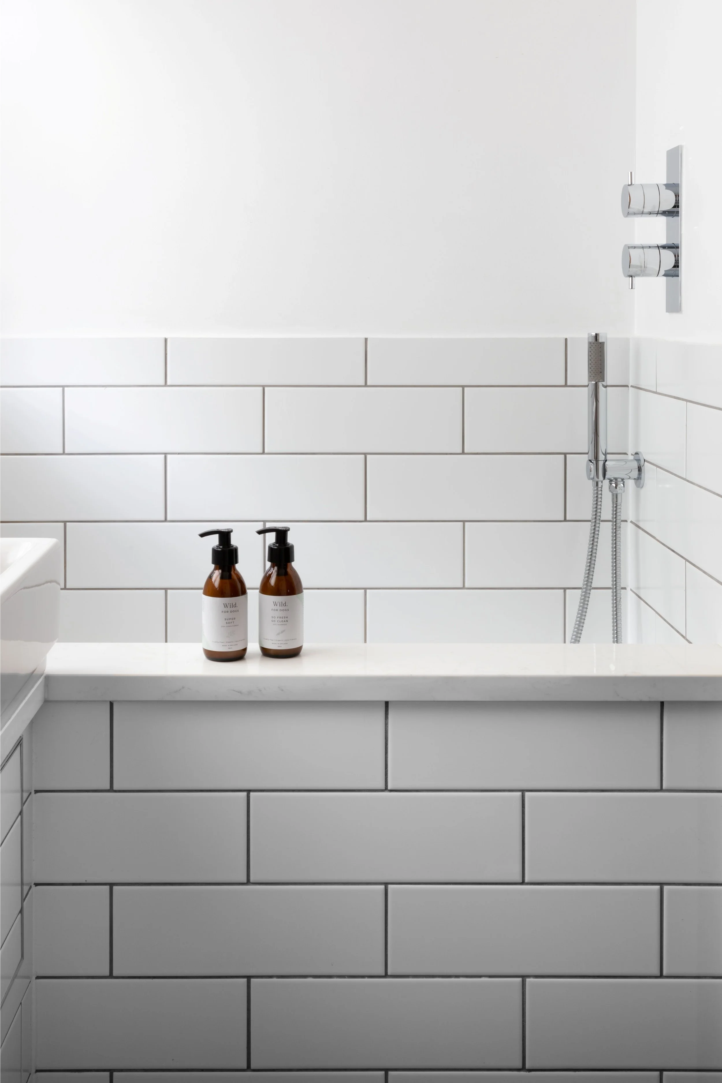 Bespoke handmade tiled dog bath in contemporary Surrey boot room.