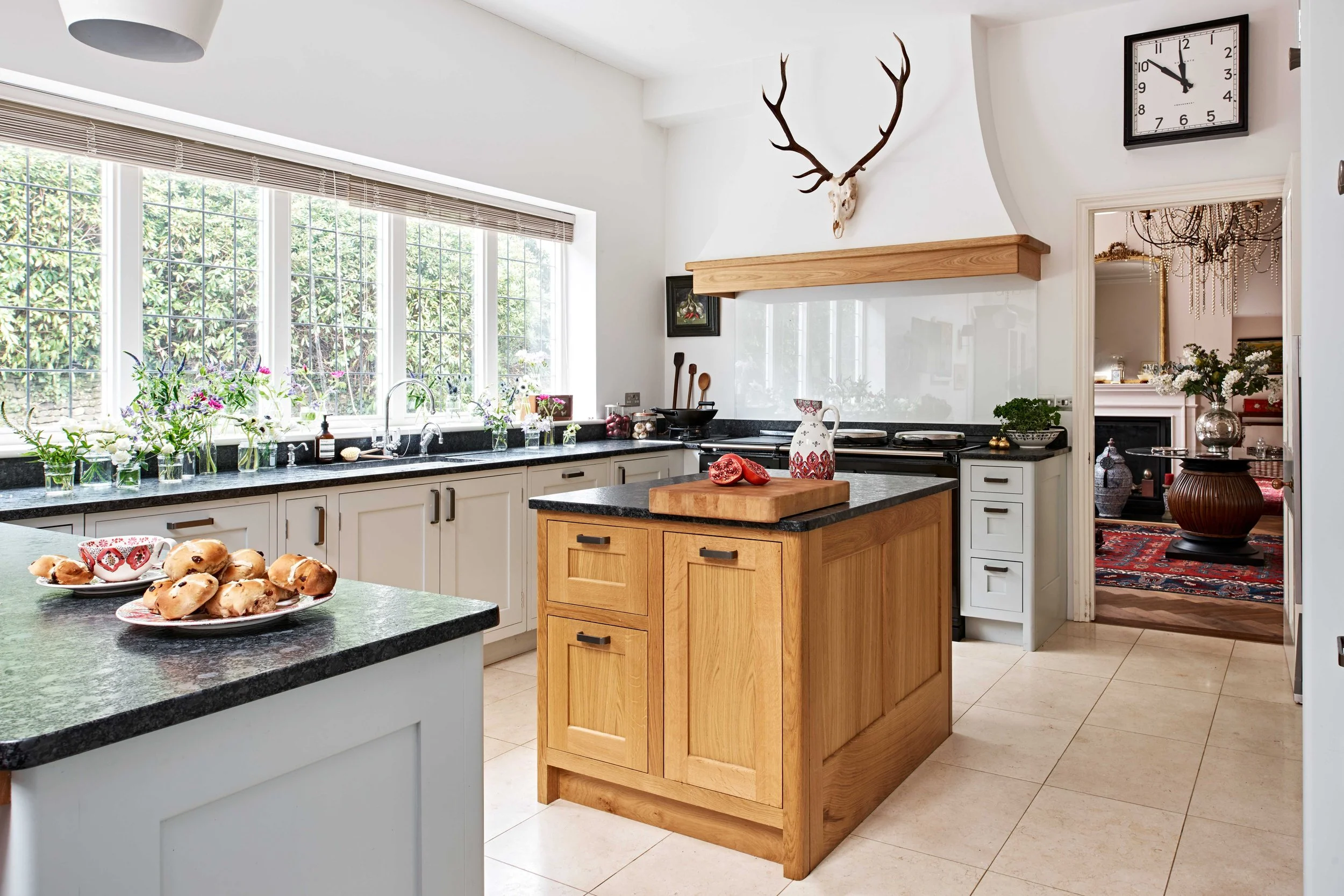 Handmade Arts and Crafts kitchen in Surrey with bespoke storage and decorative antlers.