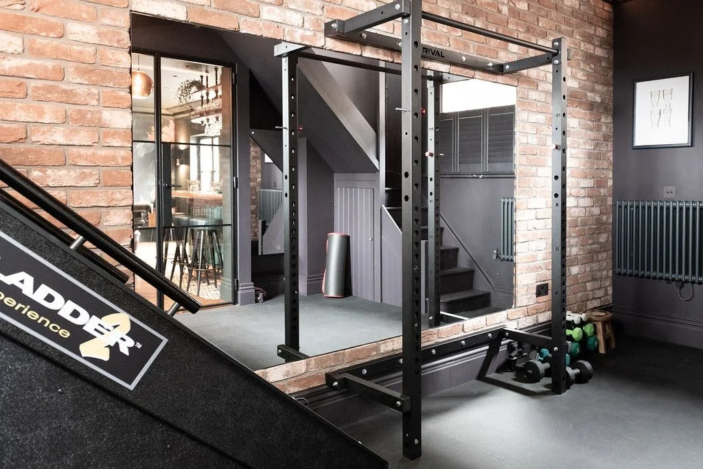 Refurbished Surrey home gym with Crittall doors linking to handmade bar and games room.