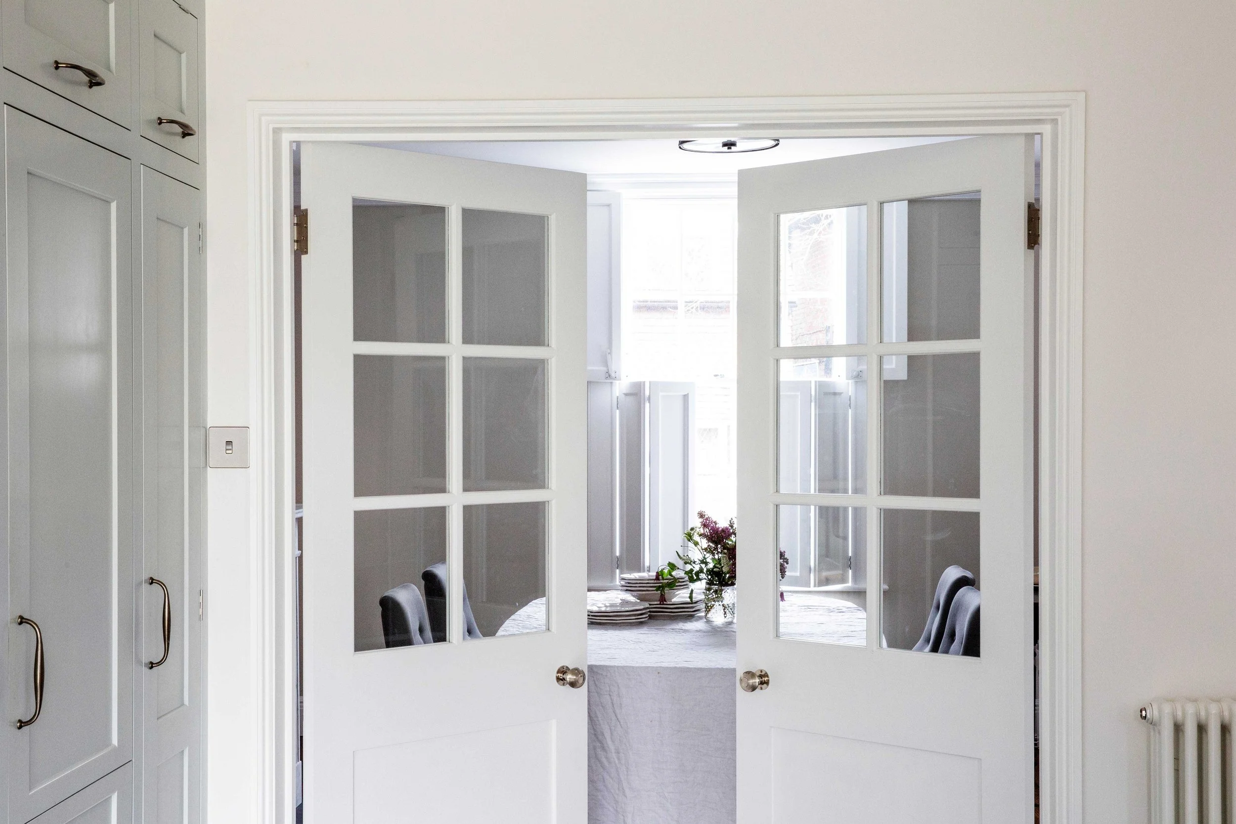 Bespoke handmade part-glazed doors leading to dining room in Georgian Surrey townhouse.