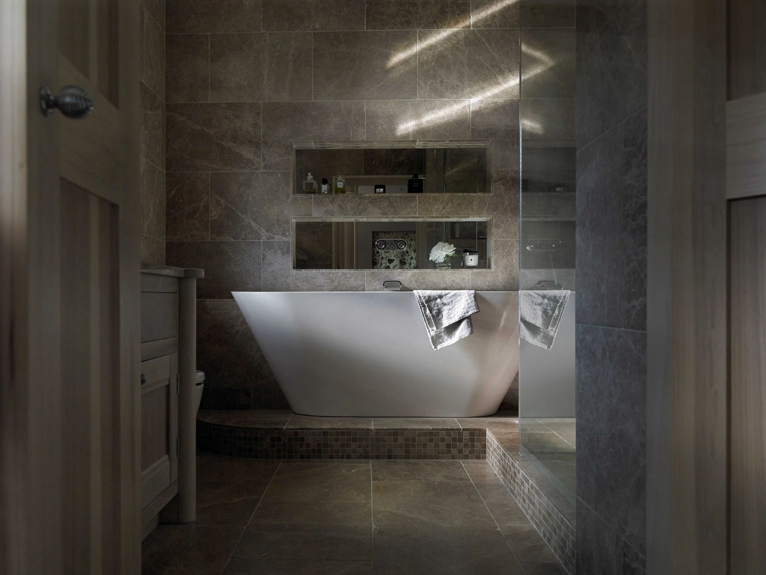 Bespoke handcrafted oak bathroom cabinetry with bath and recessed shelving