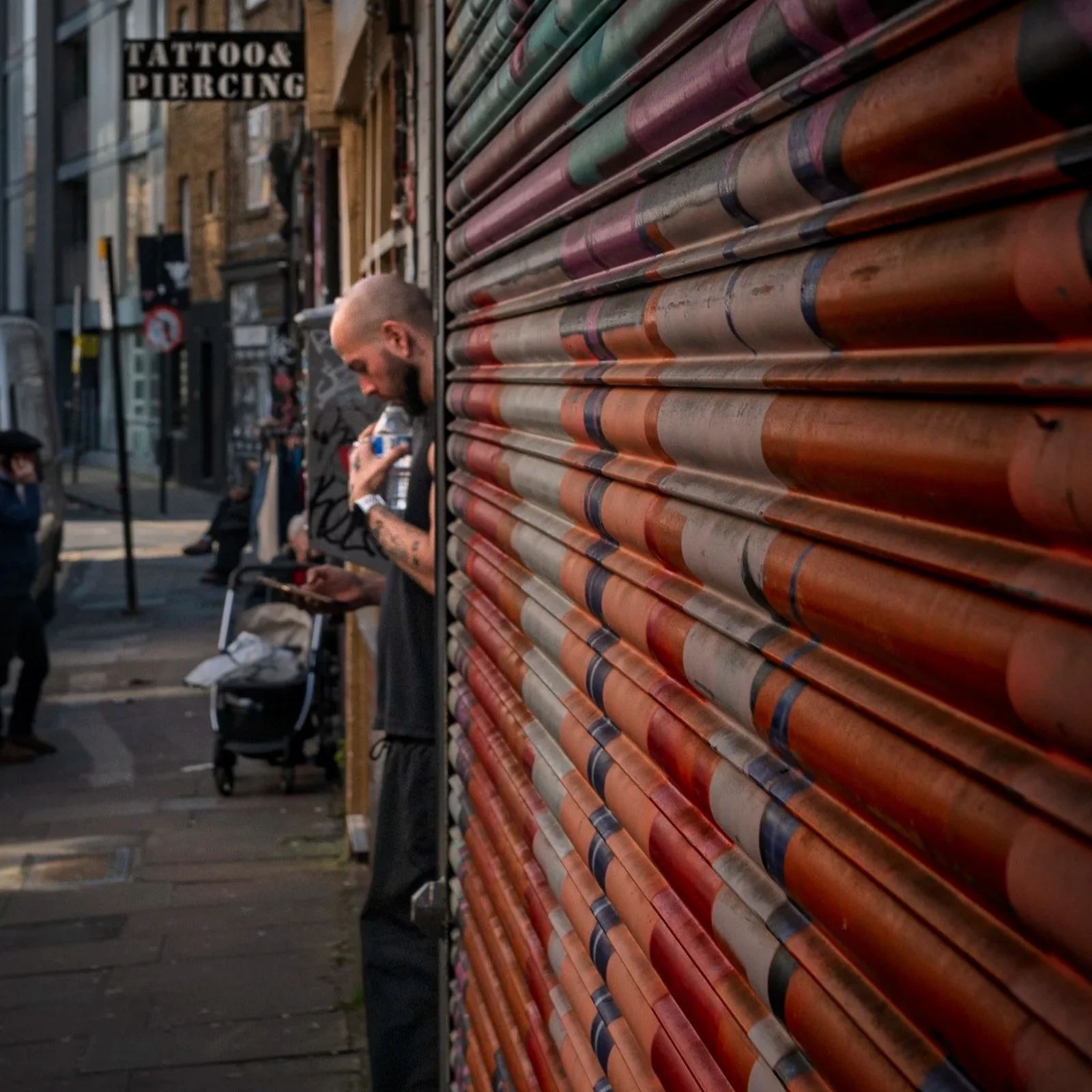 london_shoreditch_guy_smoking_roller_shutter.jpg