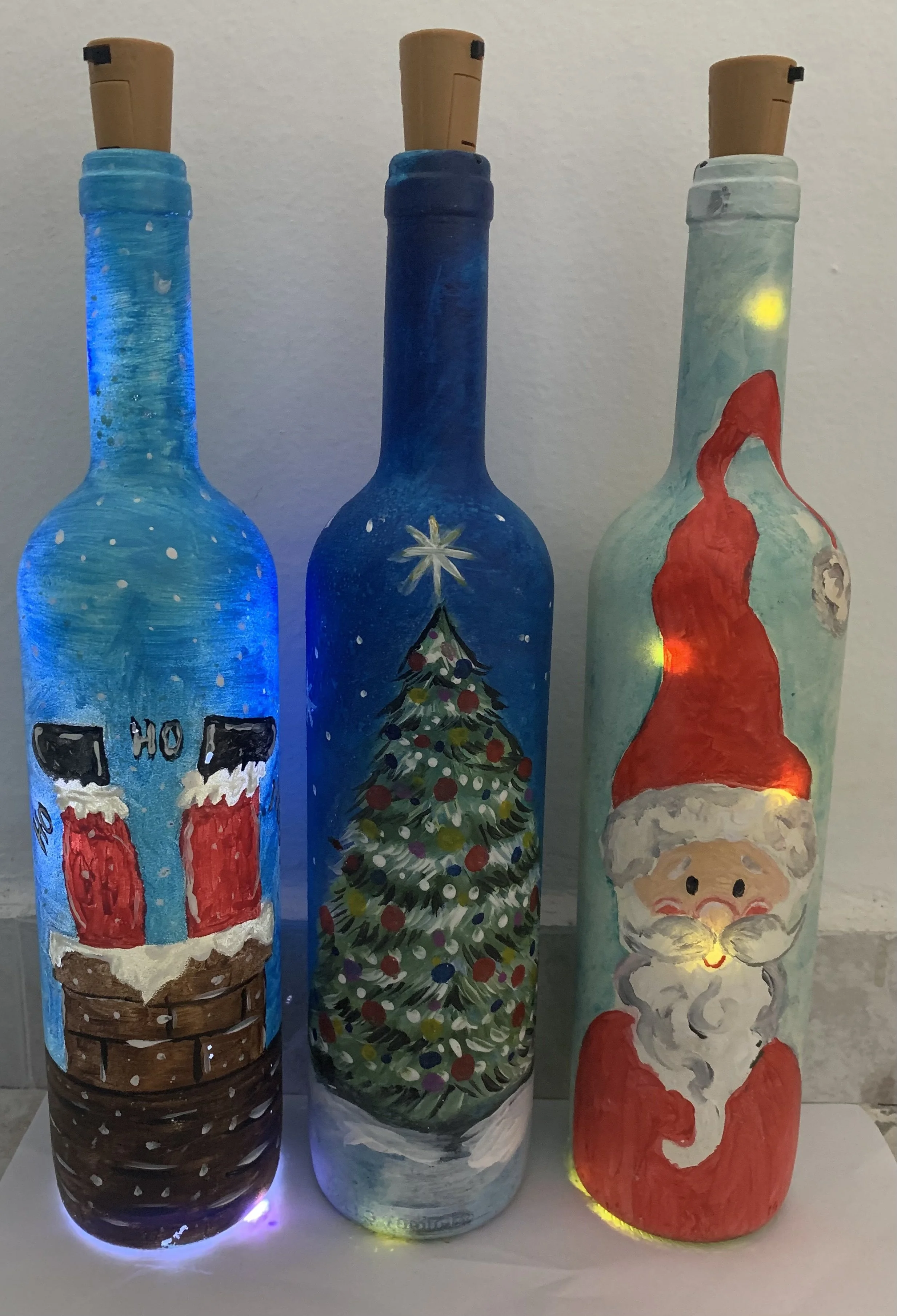Painting on to Wine Bottles to make Cute Christmas Lamps