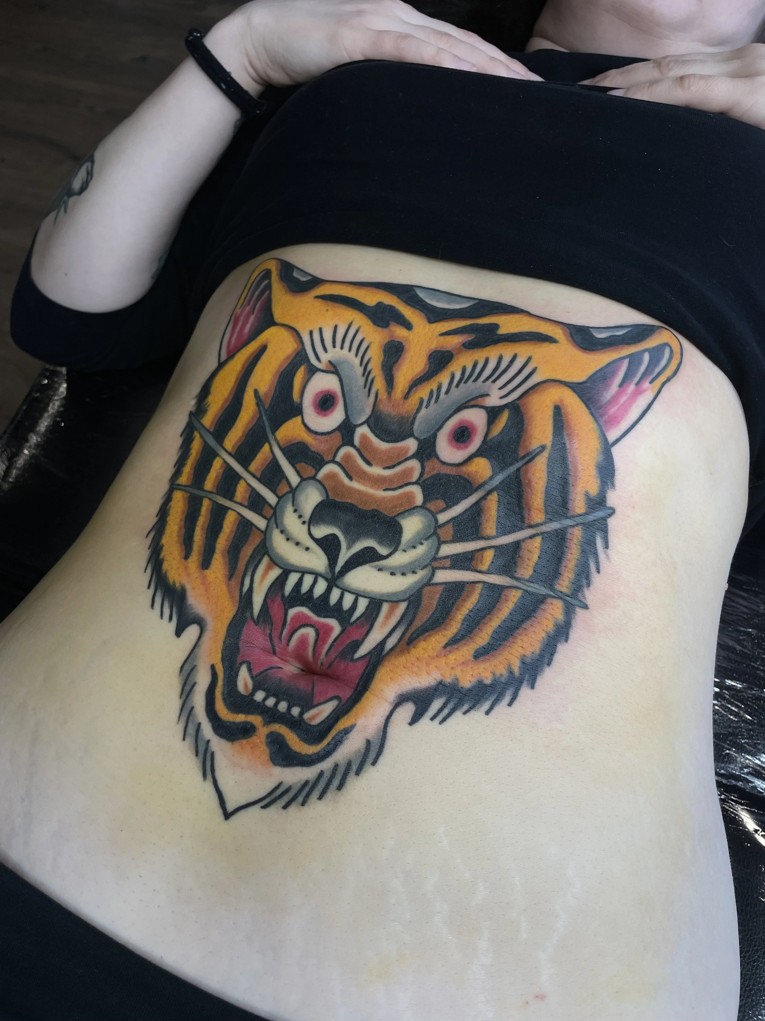 traditional tiger front tattoo.jpeg