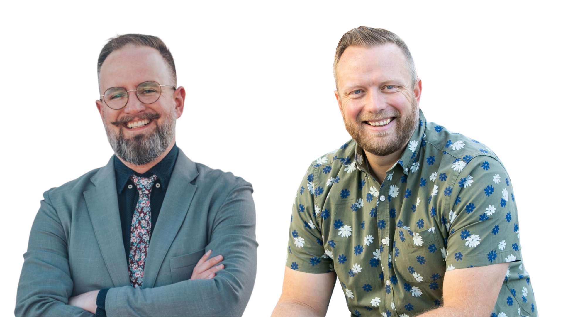 Two smiling men with beards, one wearing glasses, a gray suit with a patterned shirt and tie, the other in a floral shirt, standing and facing the camera.