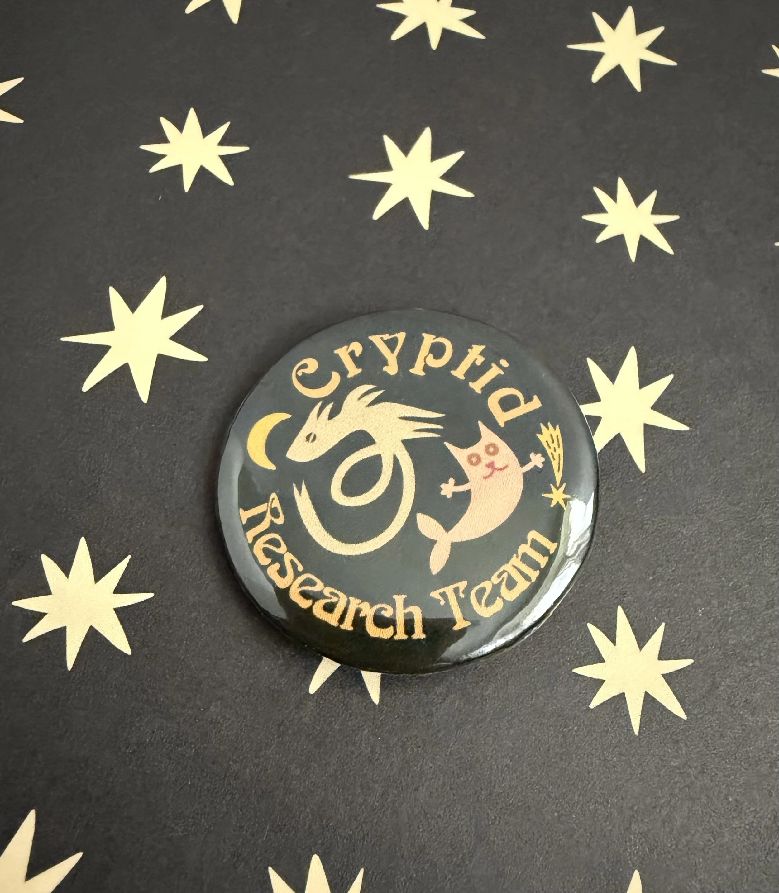 Cryptid Research Team feturing two cryptids pin button.jpeg