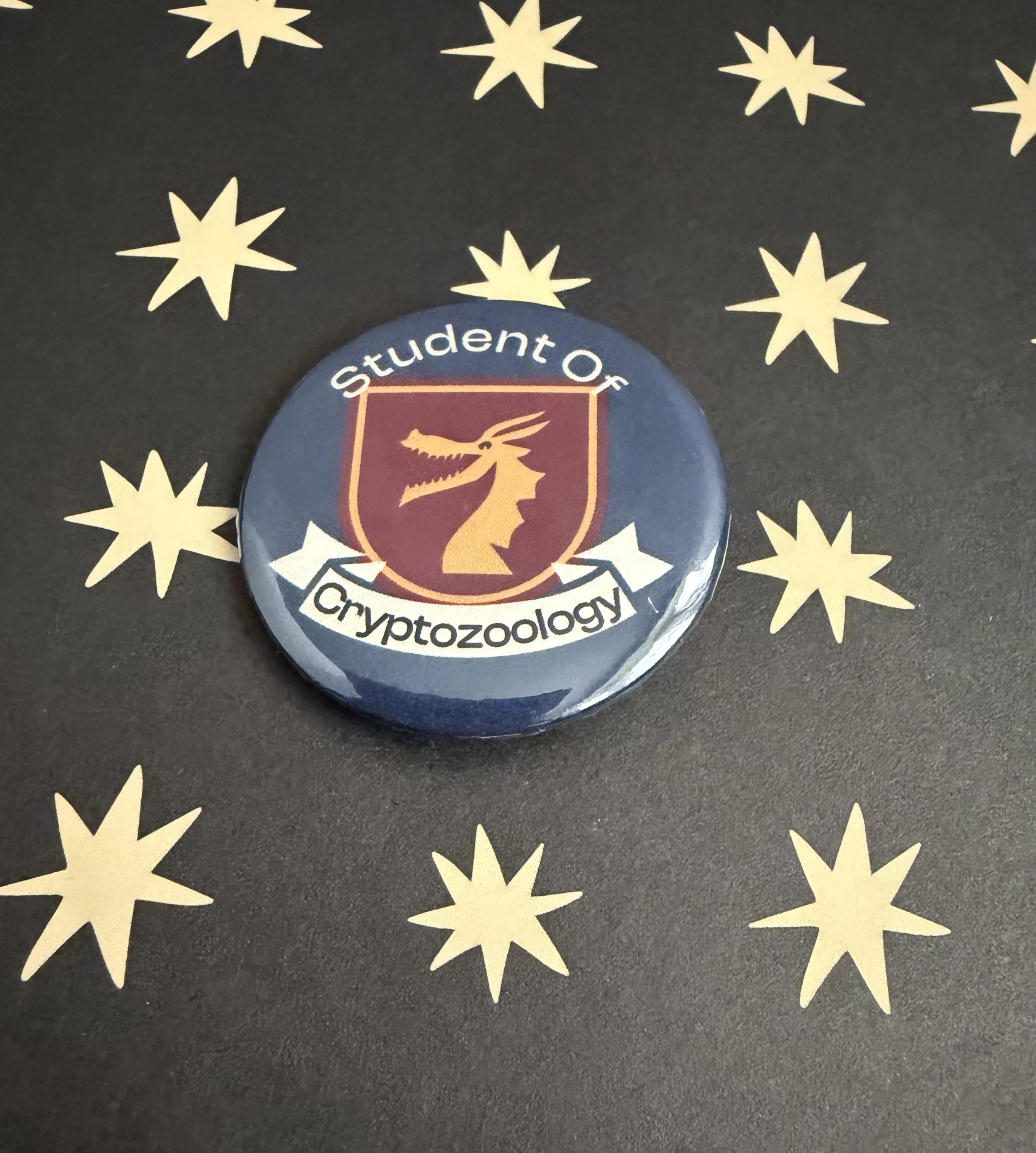 Student of Cryptozoology crest button pin.jpeg
