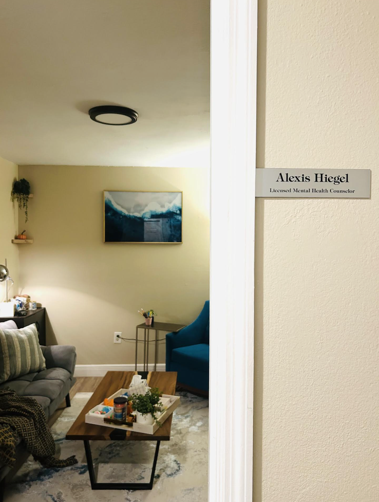 A calm, welcoming therapy office with comfortable seating and soft, warm lighting.
