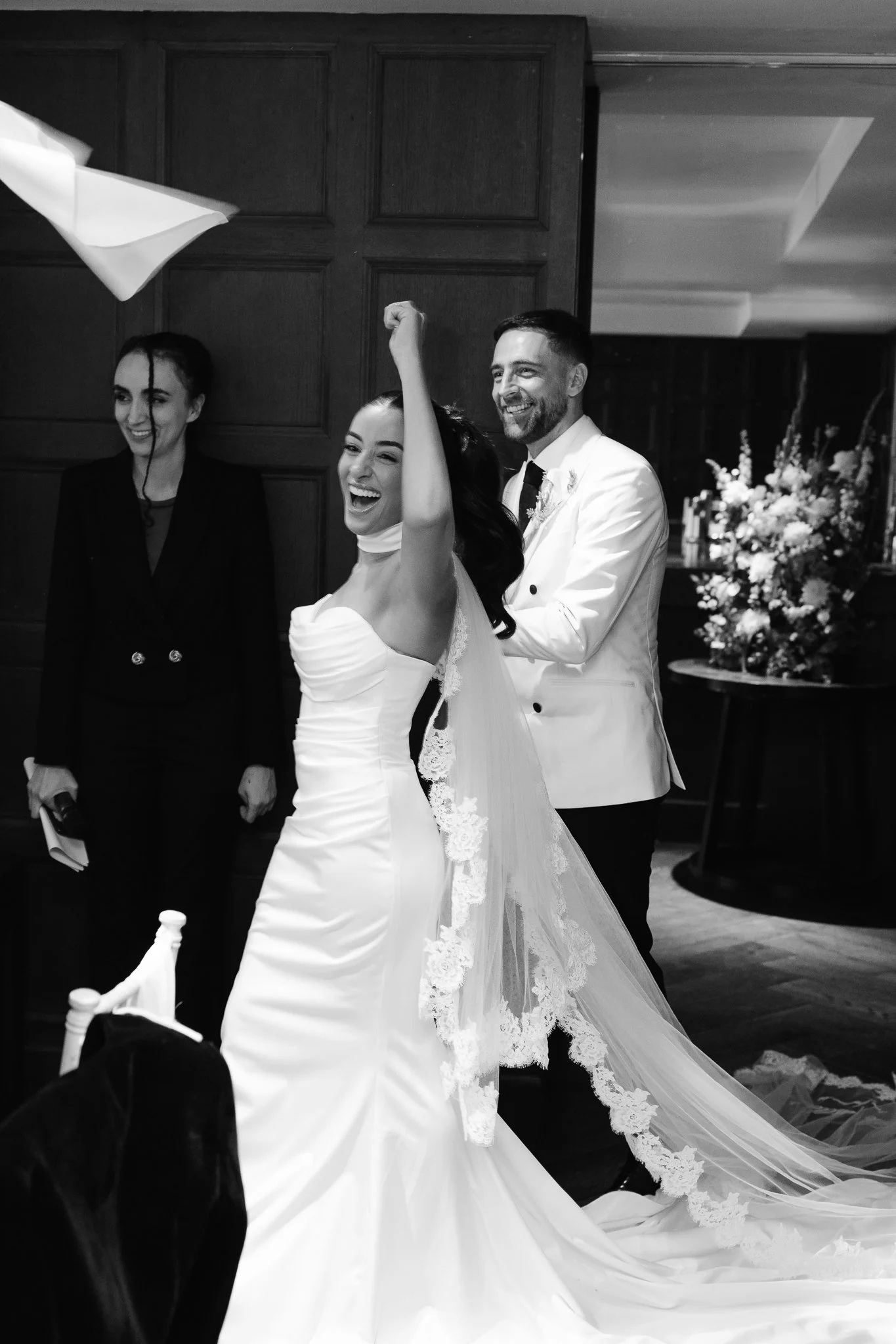 happy bride and groom are entering the dinner room for speeches