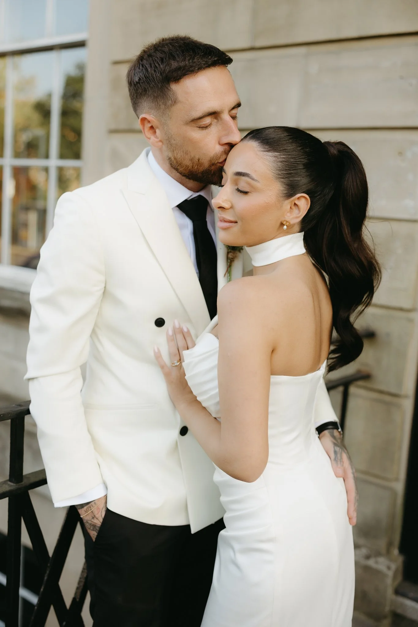 The groom is kissing the bride