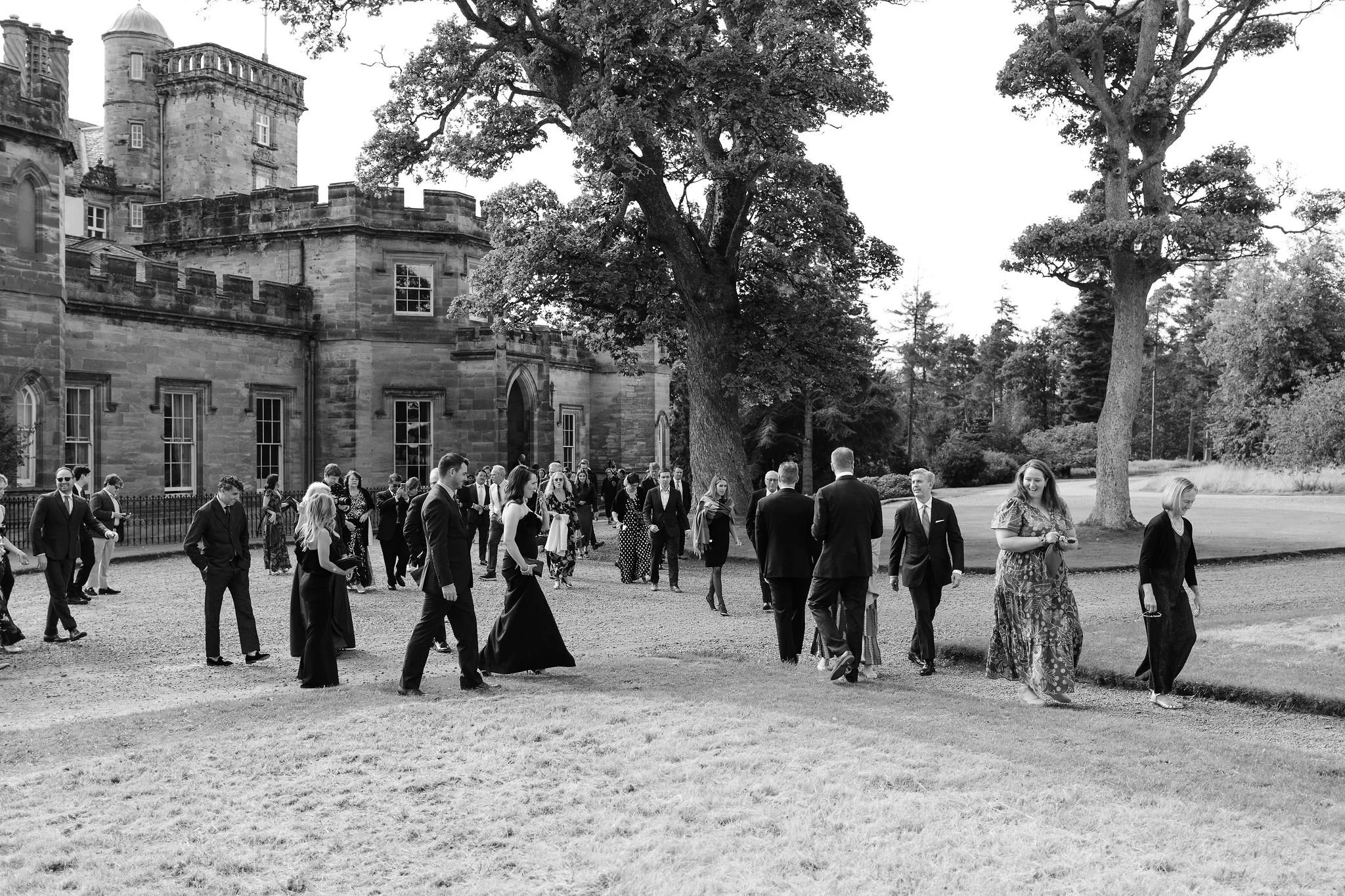 The American guests are walking to Winton garden for the outdoor wedding ceremony