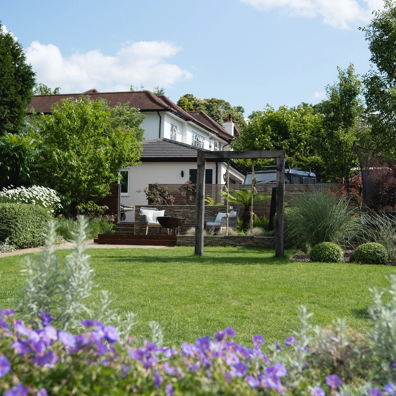 An earlier Langdale garden featuring a bespoke oak swinging seat set within raised  seating and planting.
Simple lines, crafted materials, and a layout that still feels timeless years later.
#LangdaleLandscapes #OakFrame #GardenDesign #OutdoorLiving