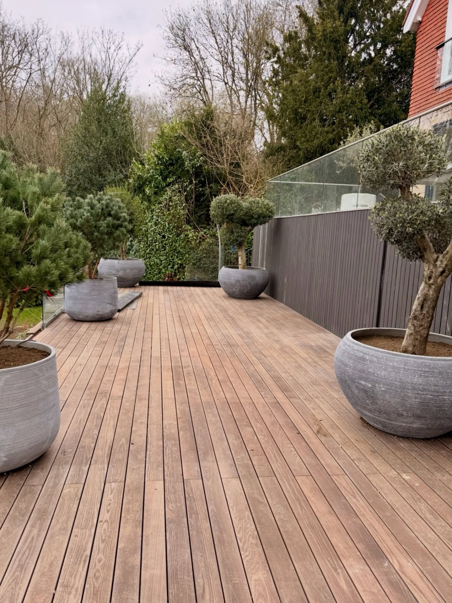 The Sevenoaks floating deck is really starting to take shape.

Thermo-ash decking going down and already lifting the whole space. We&rsquo;ve introduced large-format @torcpots planters with specimen trees from @provendernurseries to soften the struct