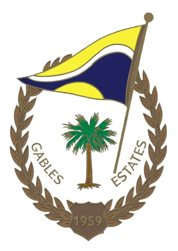 Seal with a palm tree in the center, a yellow and navy flag above, surrounded by a brown wreath, with the words 'Gables Estates' and the year 1959.