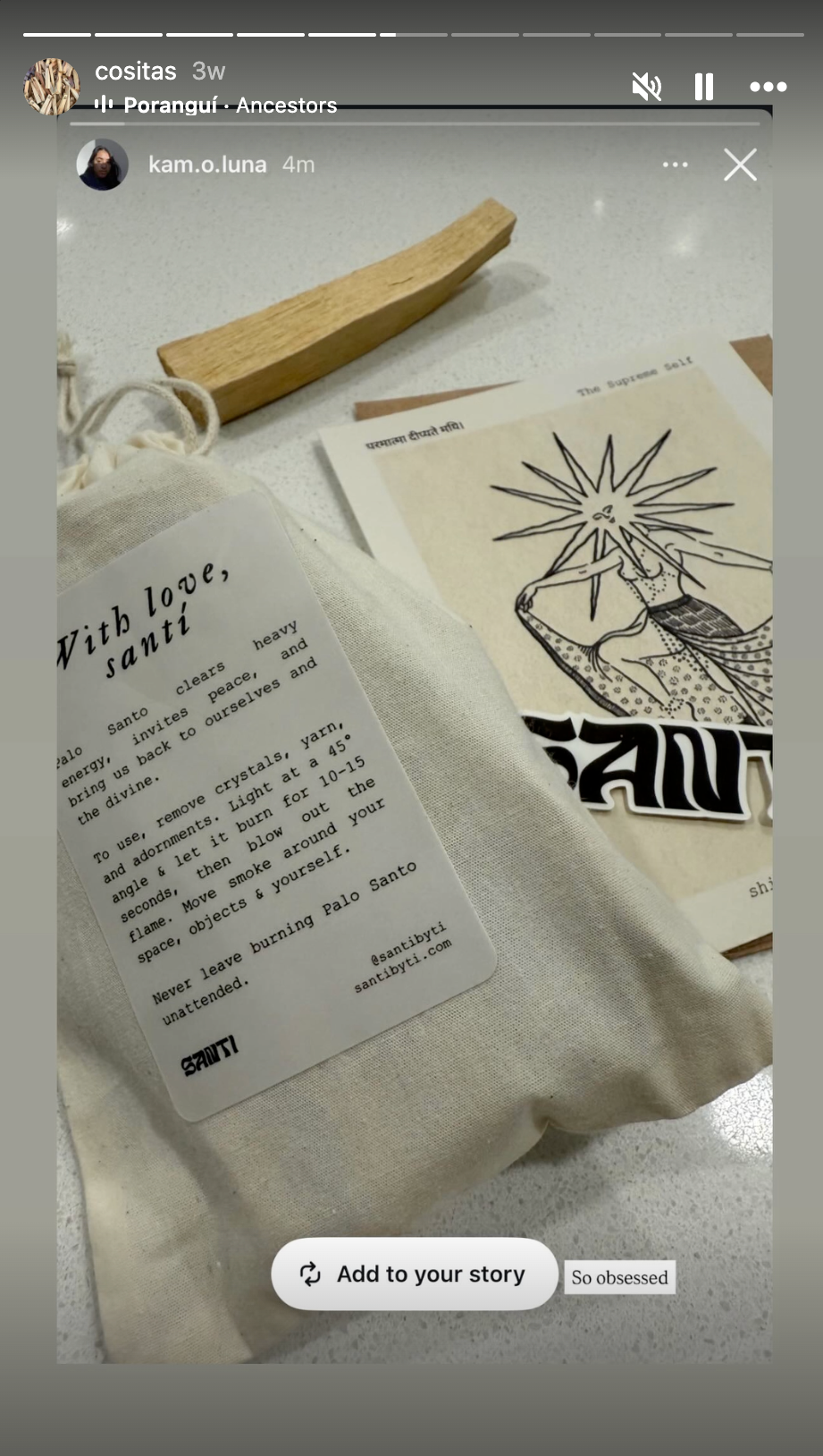 A collection of items on a table including a piece of wood, a drawing of a person with sun rays around their head, a cloth bag with a printed card about Palo Santo, and some papers with text and illustrations.