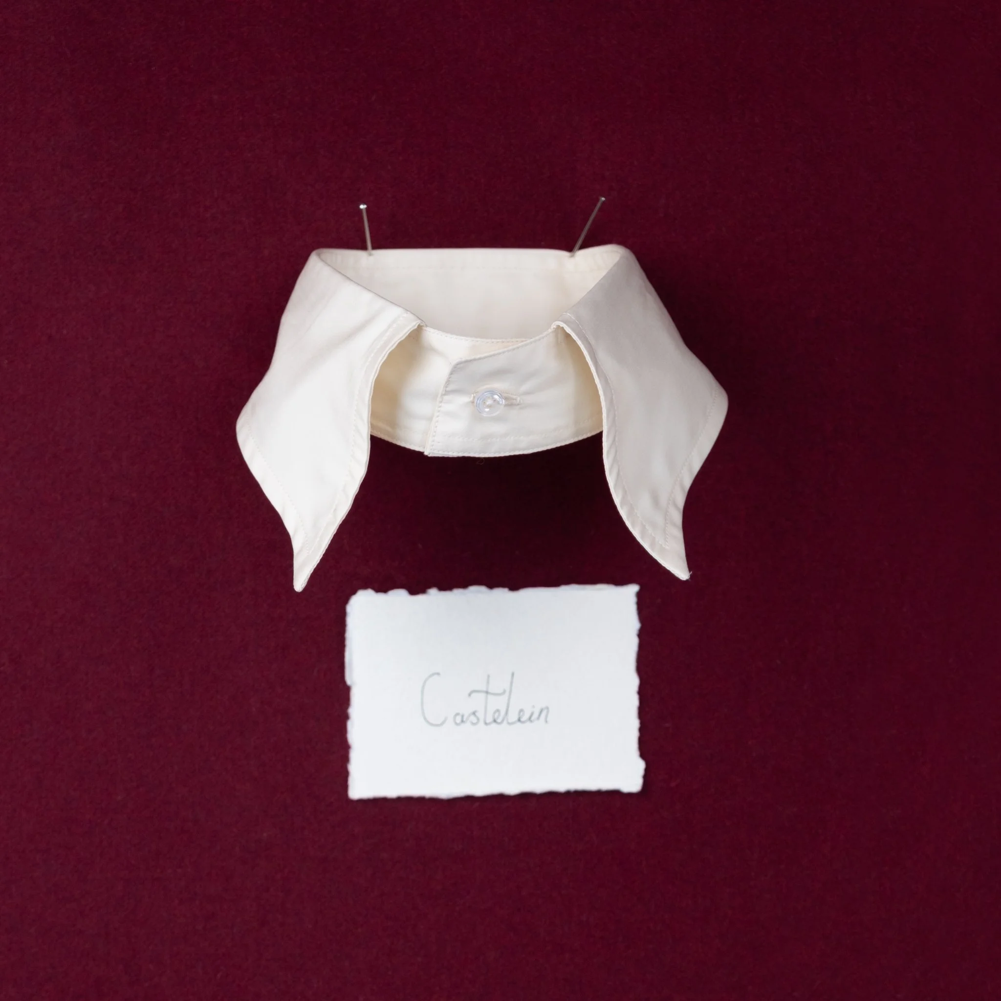 Castelein,
This collar takes inspiration from a
portrait by the artist Ernest Castelein.
James fell in love with the way the collar
appeared to sit on the models shoulders
and roll so elegantly. He set about creating
a collar that created the same im