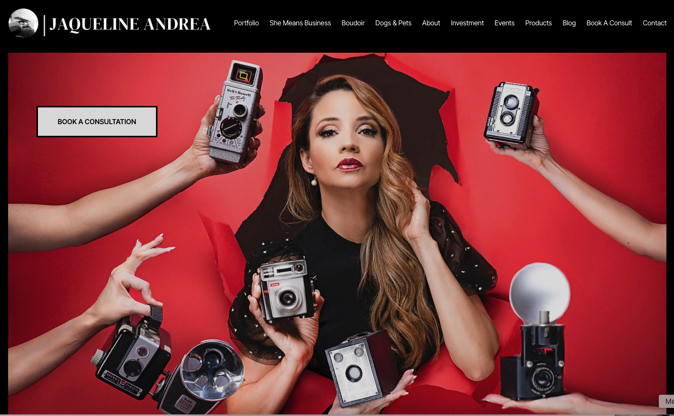 A woman with long wavy hair sitting in front of red backdrop surrounded by vintage camera equipment held by hands around her. This is an example of a Squarespace Website Designer for Small Business.