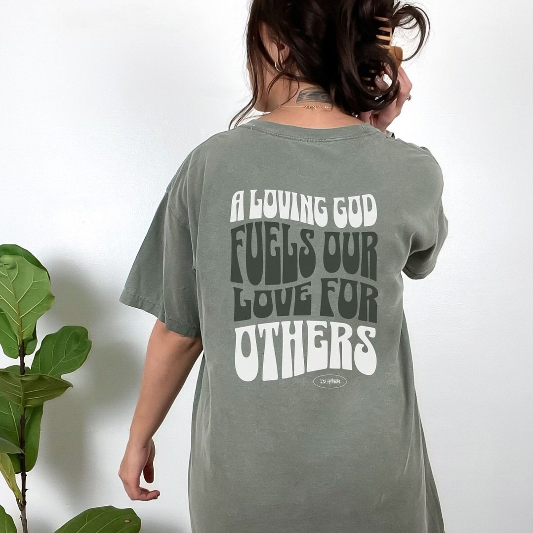 Part of our Retro Drop... Meet our A LOVING GOD TEE. Crafted with care and adorned with elegant typography, this shirt serves as a visual reminder of the boundless love that flows from our Creator. As we bask in the warmth of His love, we are empower