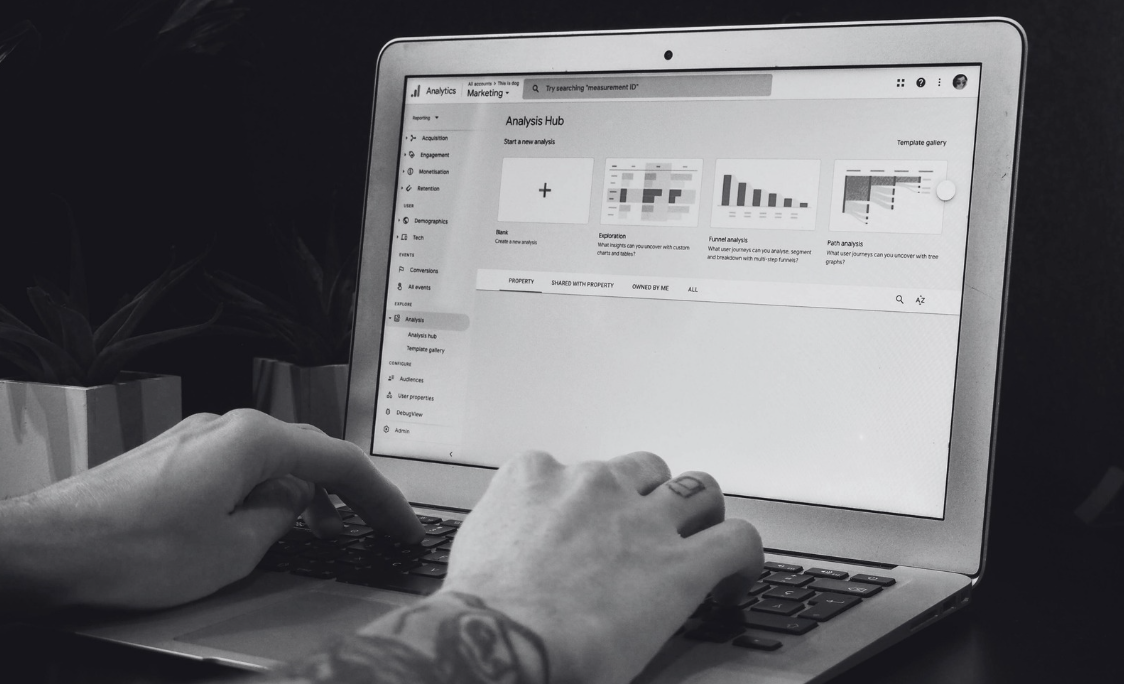 Person's fingers hovered over a laptop keyboard