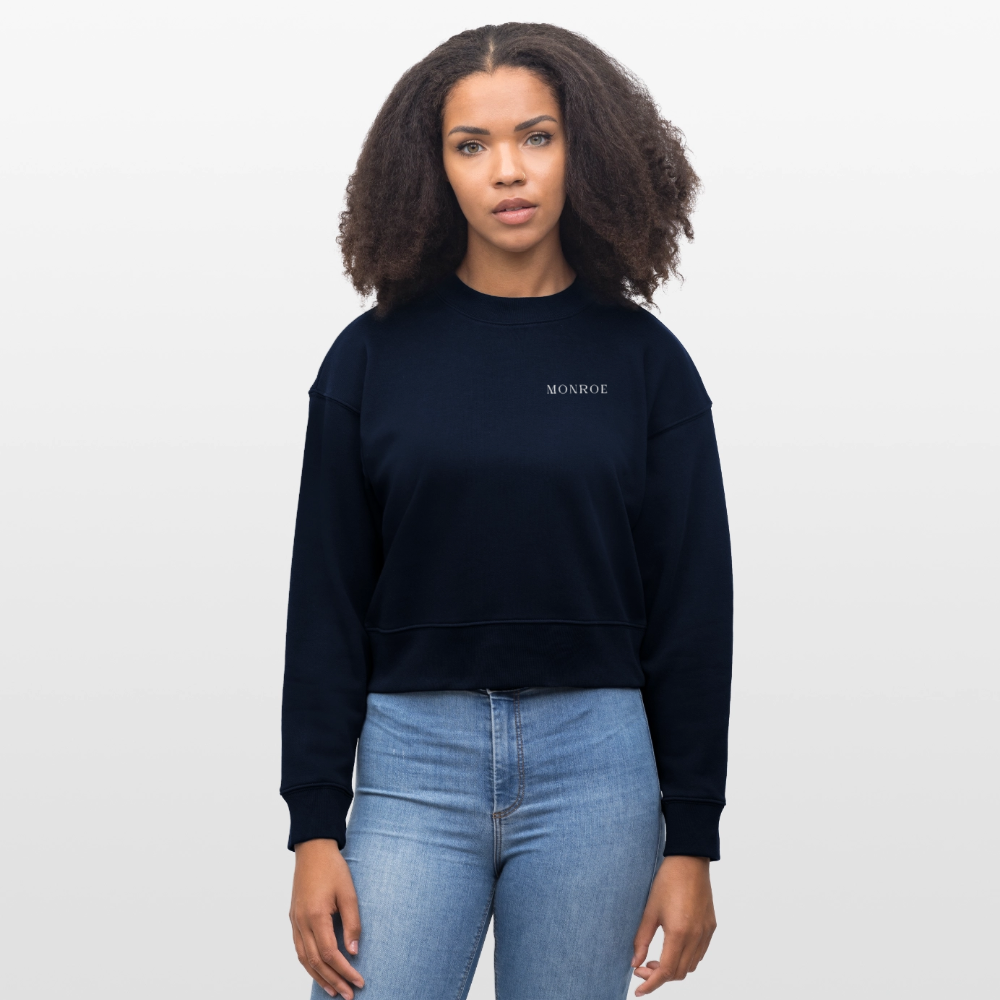 Young female in a cropped navy sweatshirt