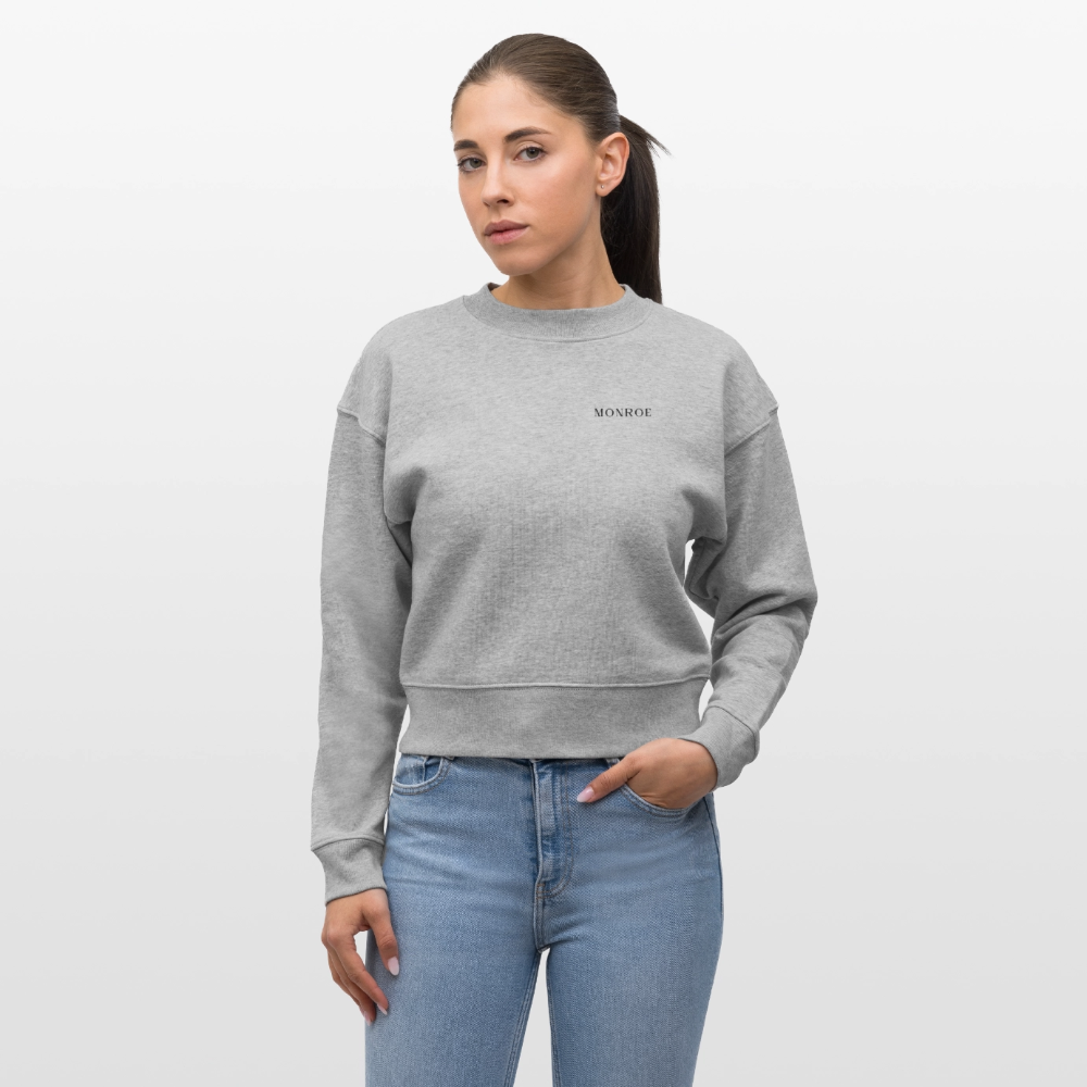 Young female in a cropped grey sweatshirt