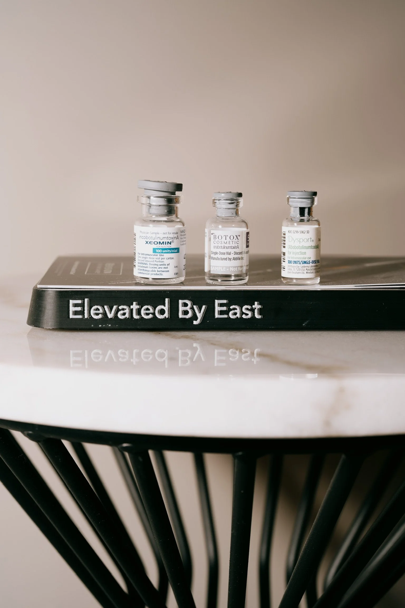 Woman's legs in black high heels sticking out of vintage clawfoot tub against floral wallpaper background.