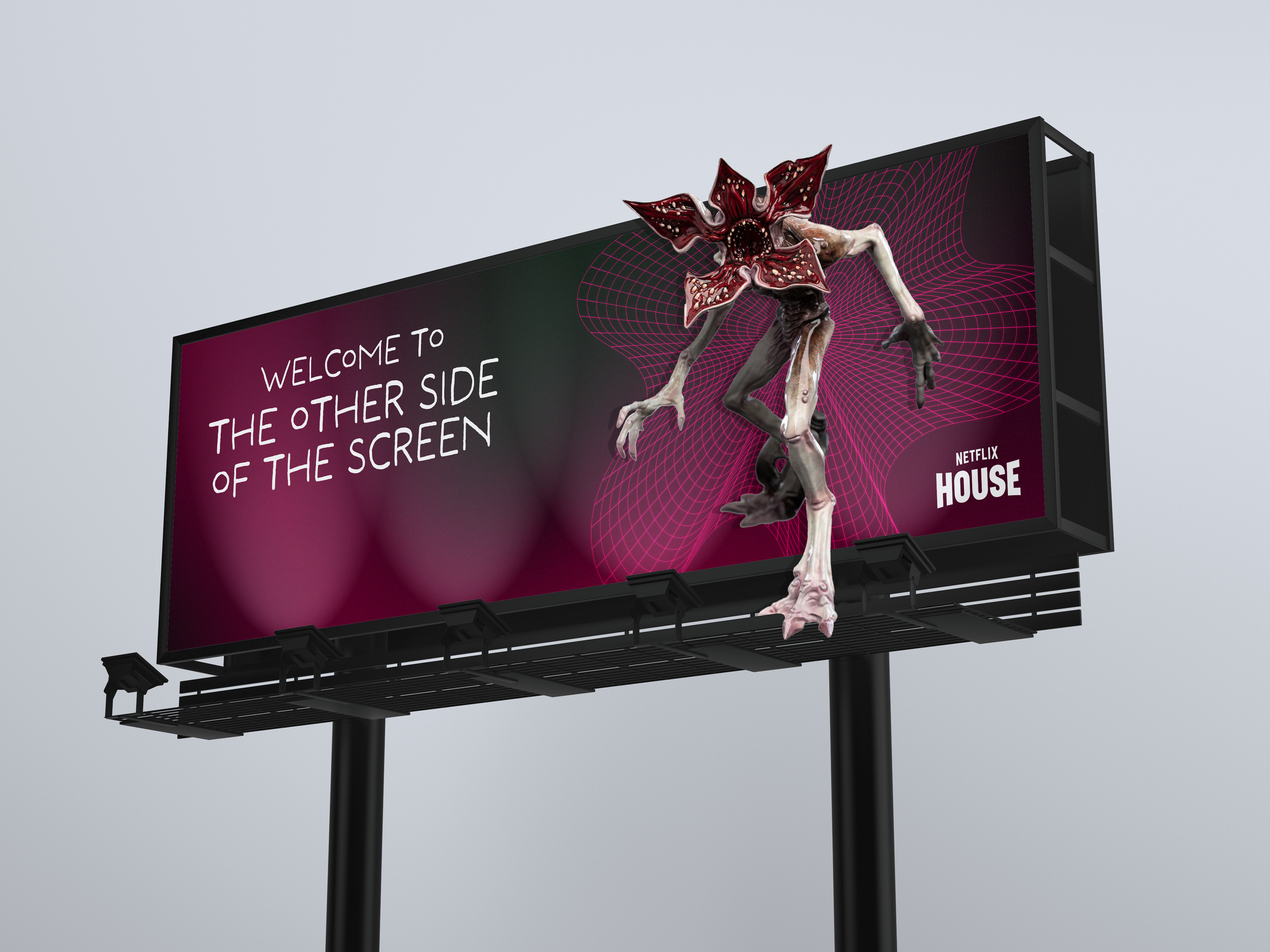 A billboard featuring the Demogorgon from the Netflix series, Stranger Things, standing in front of a digital grid background. The billboard reads, "Welcome to the other side of the screen" and "Netflix House."