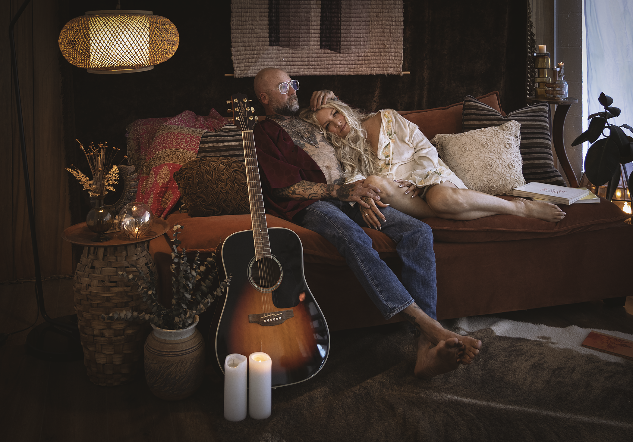 Couple photographed on a vintage-inspired sofa during a music-inspired editorial portrait session for Stripped Down Sessions at Love Street Pictures.