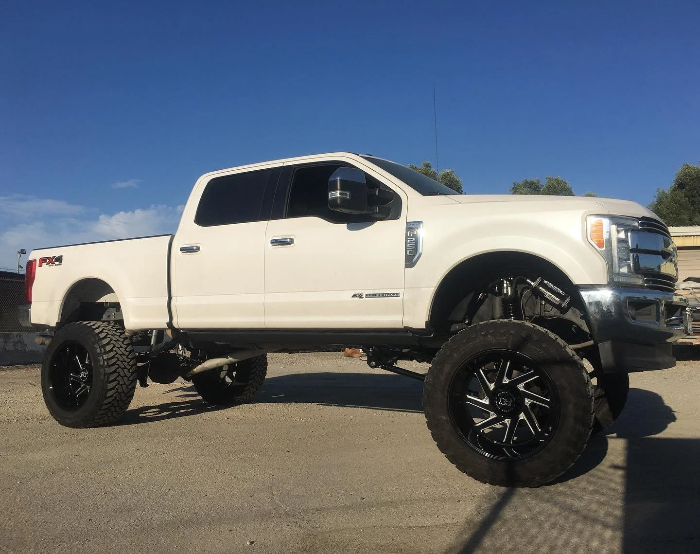 White Ford truck with lift kit