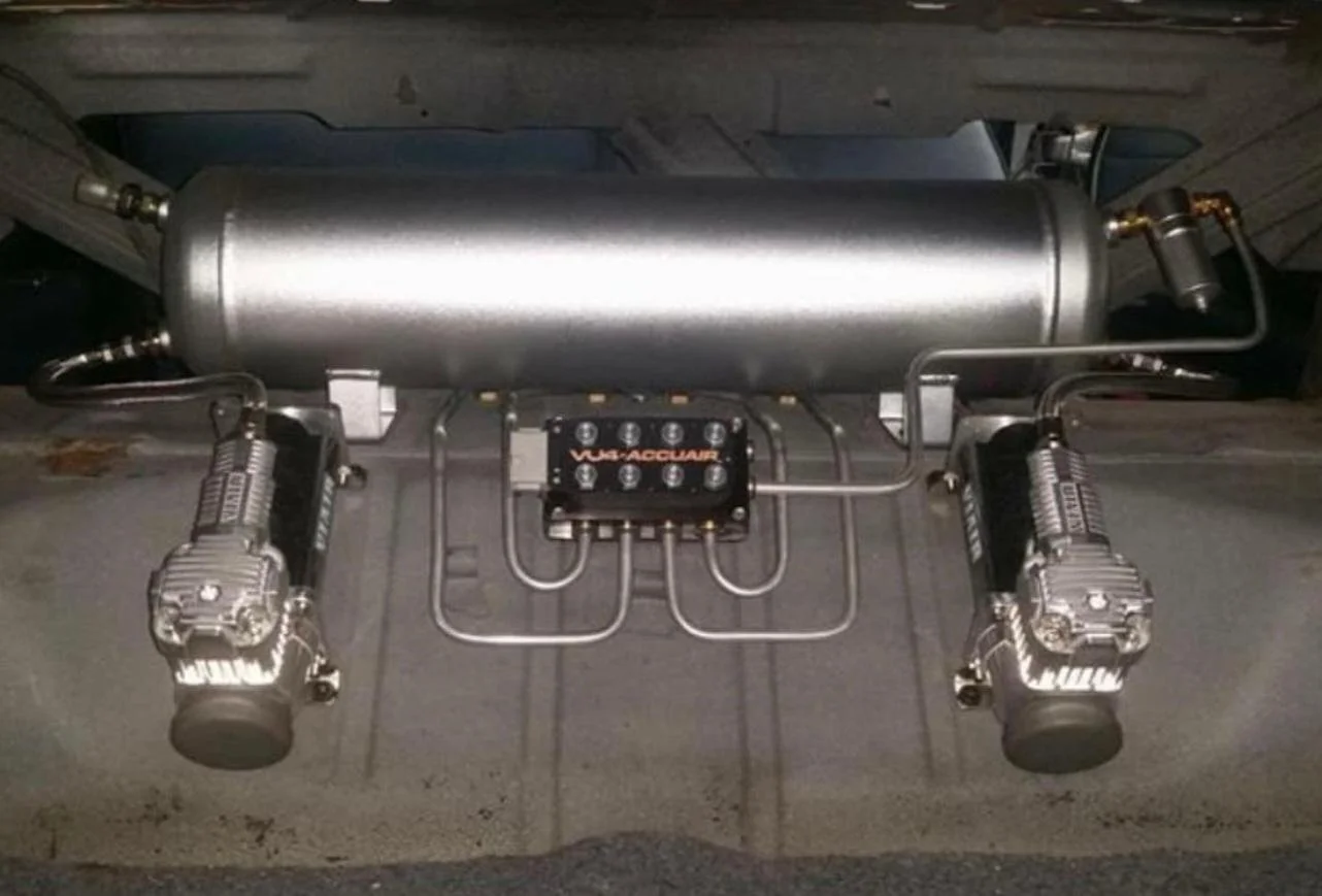 A turbocharger setup with dual wastegates, mounted on a wooden surface.