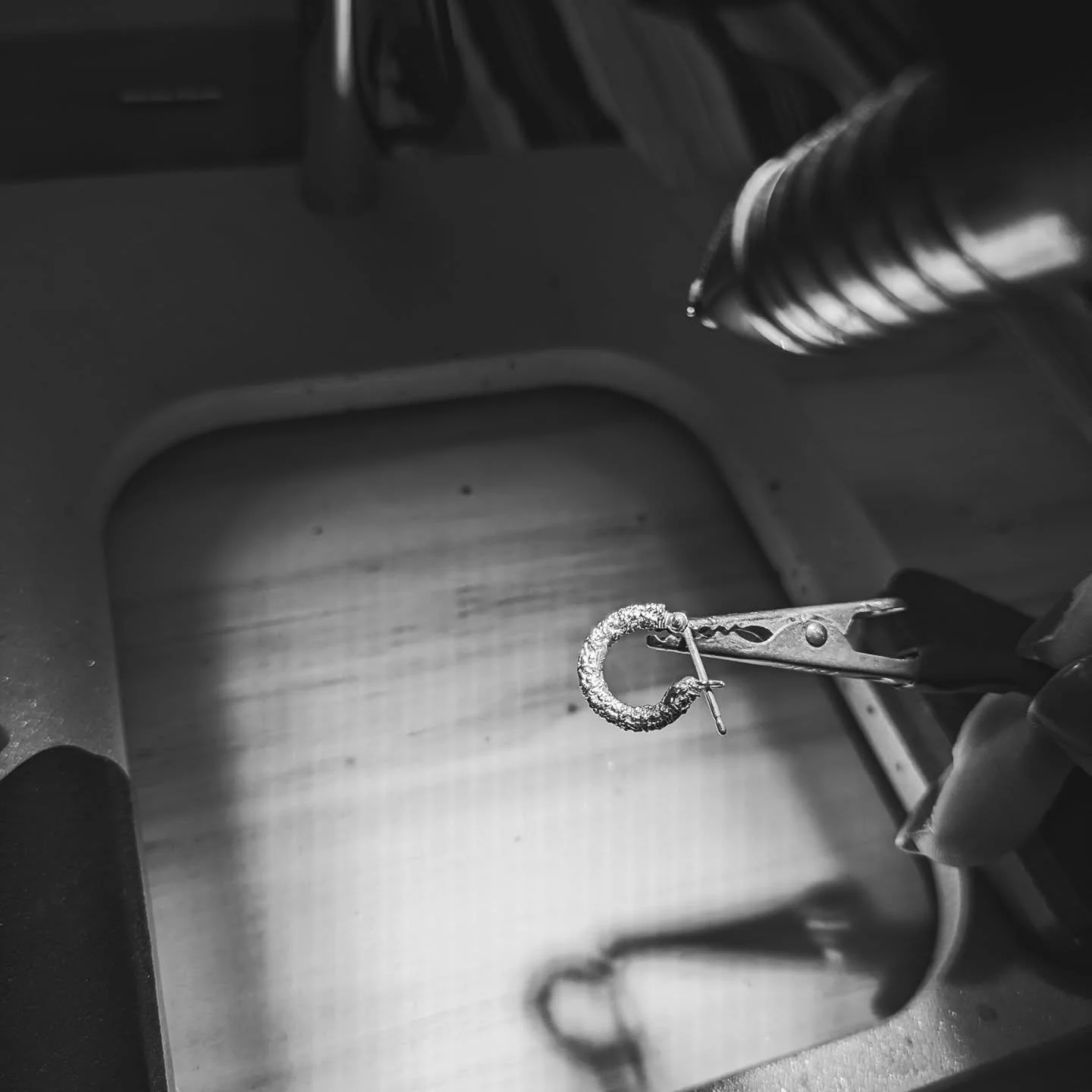 Today I was finishing off the silver samples of the new chunky hoop earrings by PUK welding the earring joint. I like having the little ball ended rivets - taking a pic through a microscope isn't easy, but managed to get a close up of the process. Ho