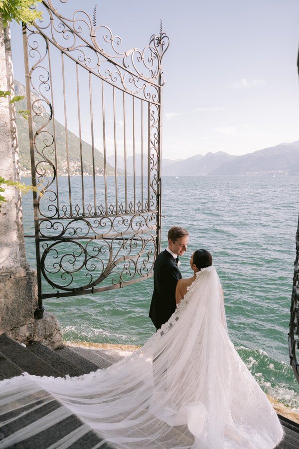 my-lake-como-wedding-planning-planner-expert-italy-mountains-lake-lakeside-bride-groom-married-large-lace-veil-romantic-couple