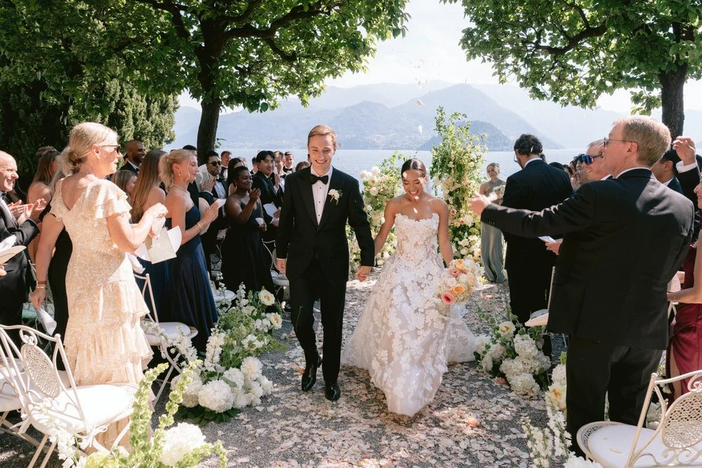 my-lake-como-wedding-planning-planner-expert-italy-bride-groom-ceremony-guests-aisle-mountains-sunny-outside-celebration