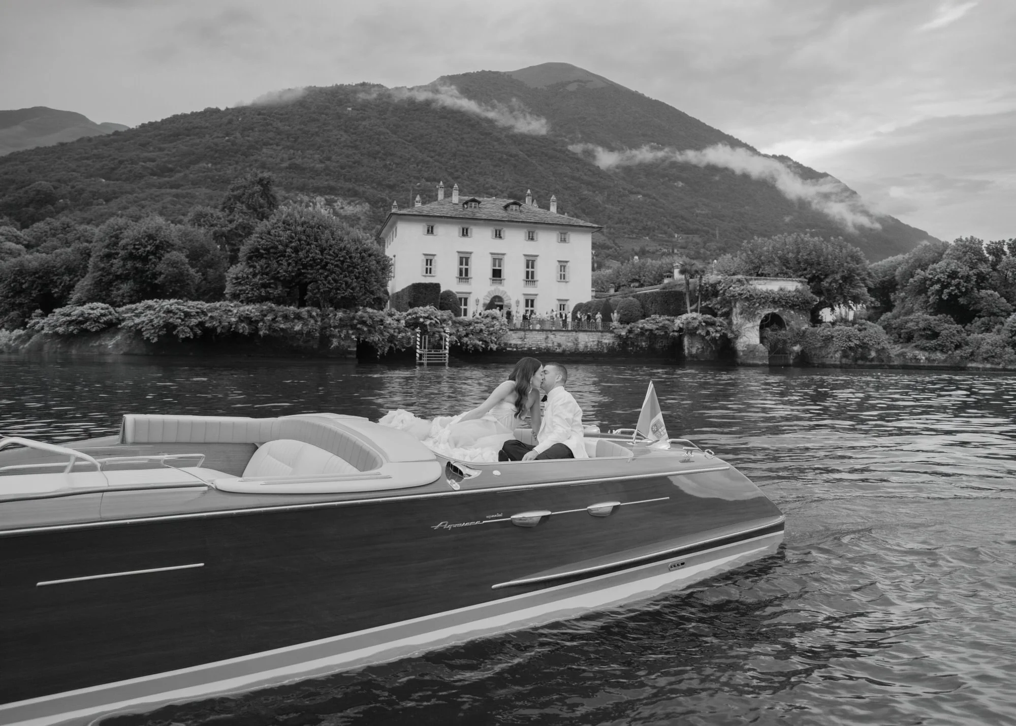 black-and-white-couple-married-kissing-boat-lake-water-romantic