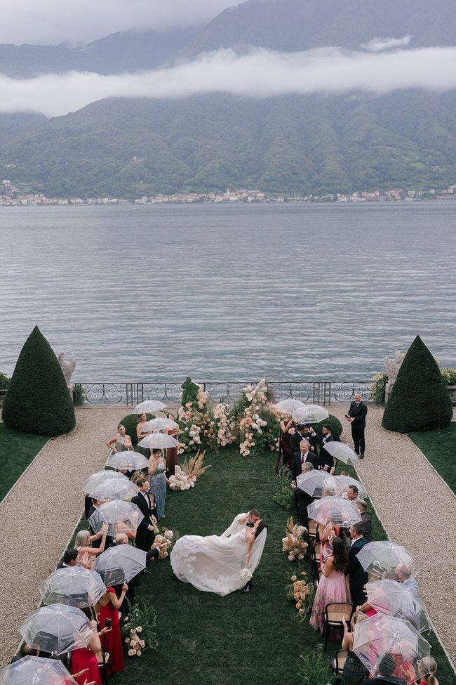 my-lake-como-wedding-italy-planner-umbrellas-rain-guests-bride-groom-married-mountains