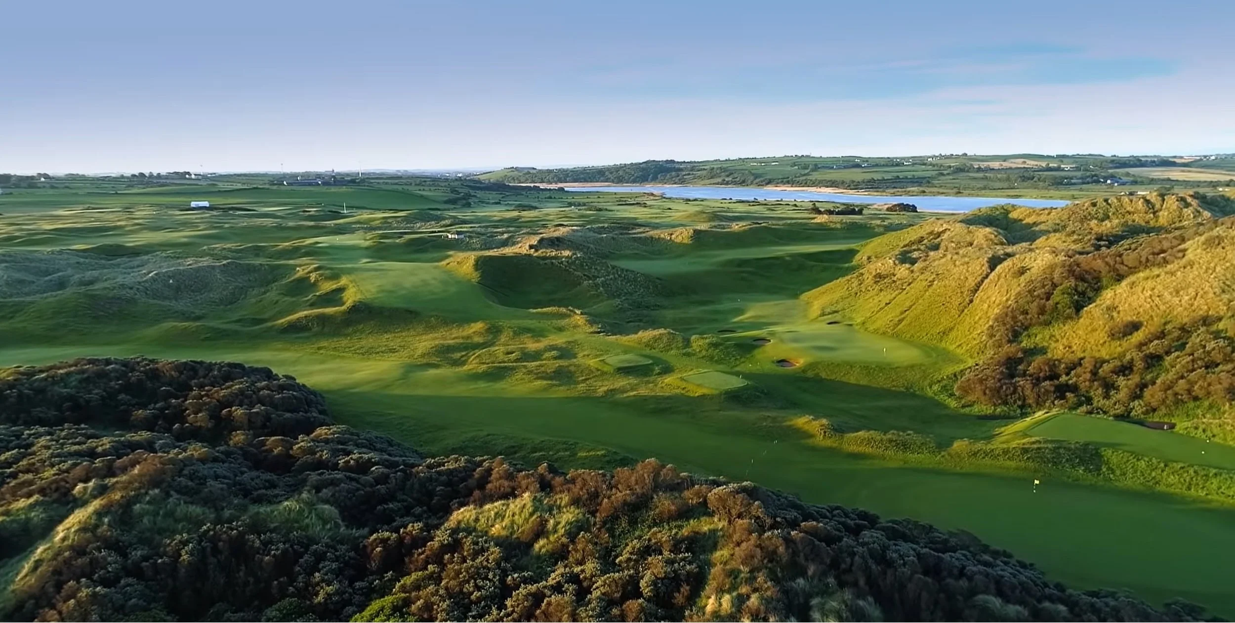 Portstewart Golf Club’s Strand Course with towering dunes, championship links fairways, and the Atlantic coastline in Northern Ireland