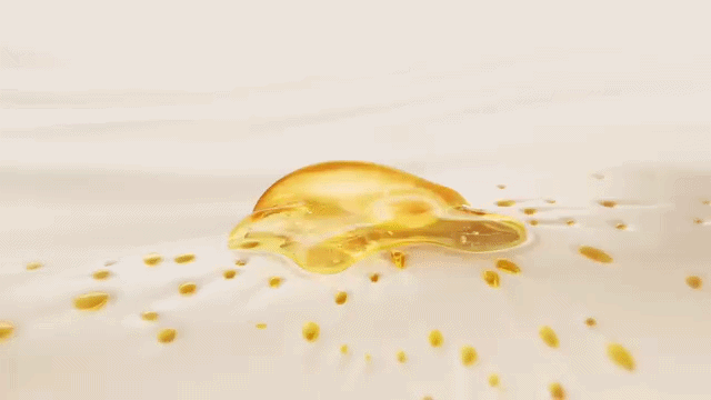 an animation of a oily droplet bubble getting bigger when little oily bubbles that slide on a cream join