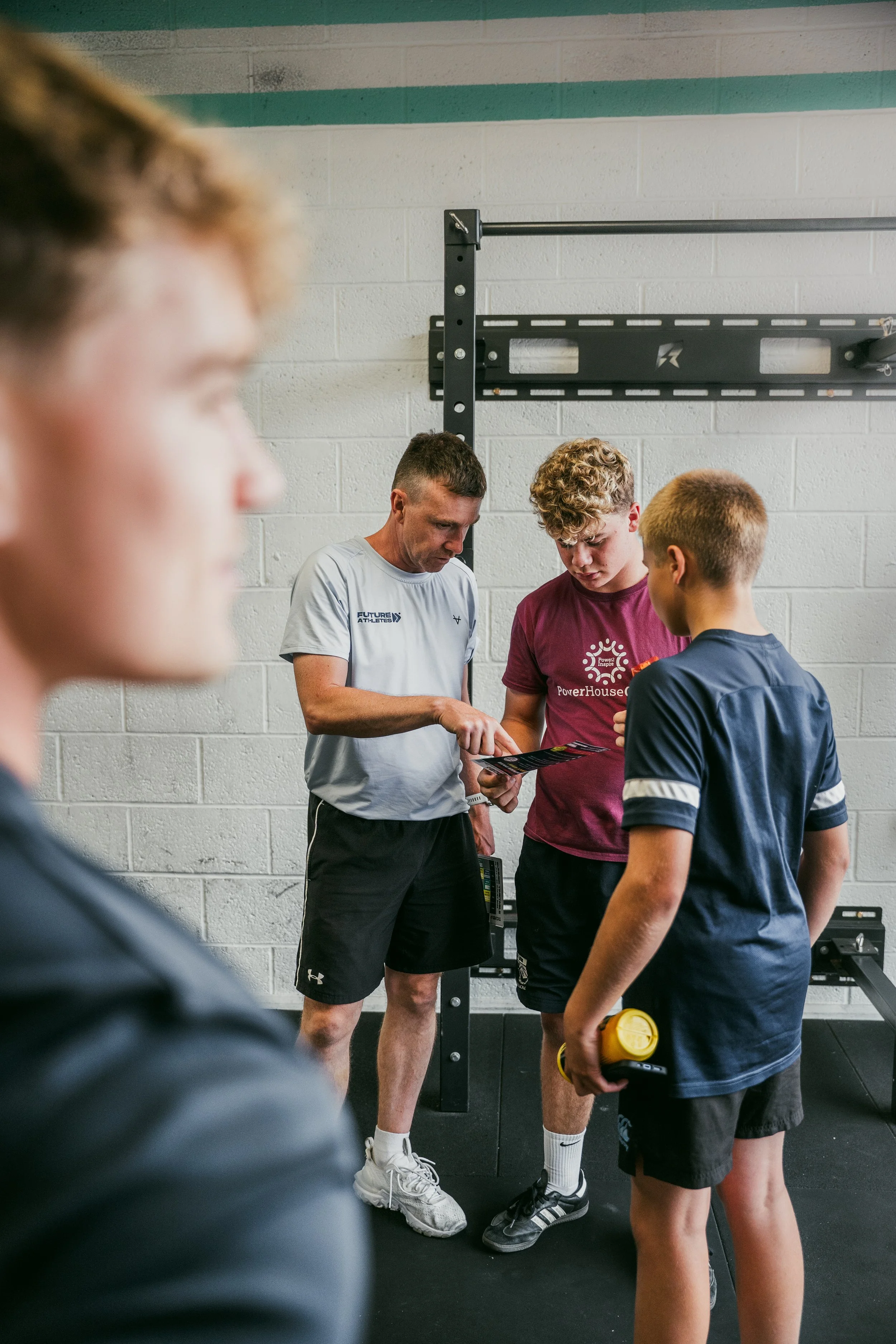 Adam discusses plans with two young athletes