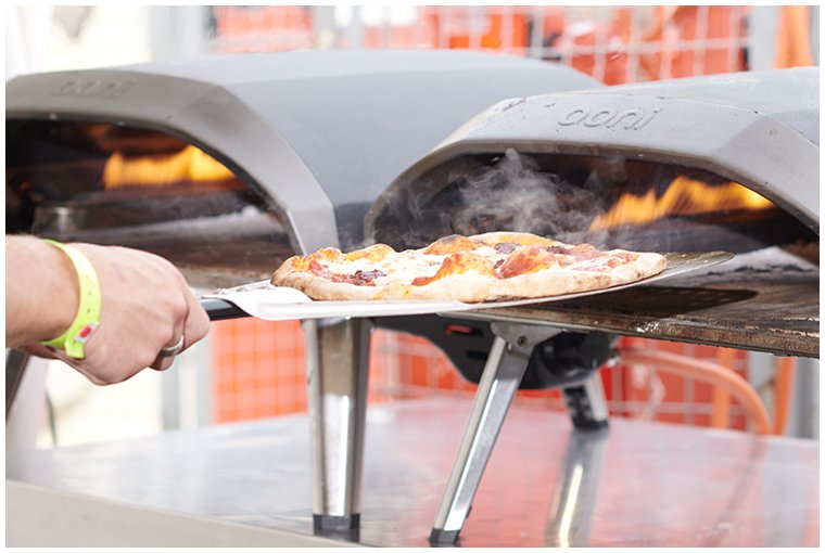 pizza-being-placed-in-oven-at-festival.jpg