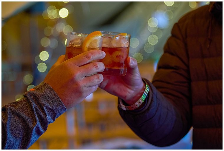 customers-clinking-glasses-at-festival-bar.jpg