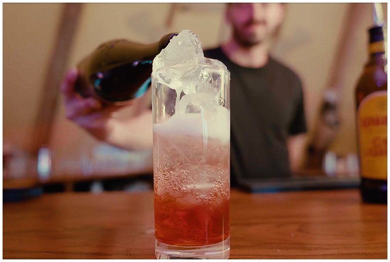 barman-pouring-champagne-cocktail-at-festival-bar.jpg